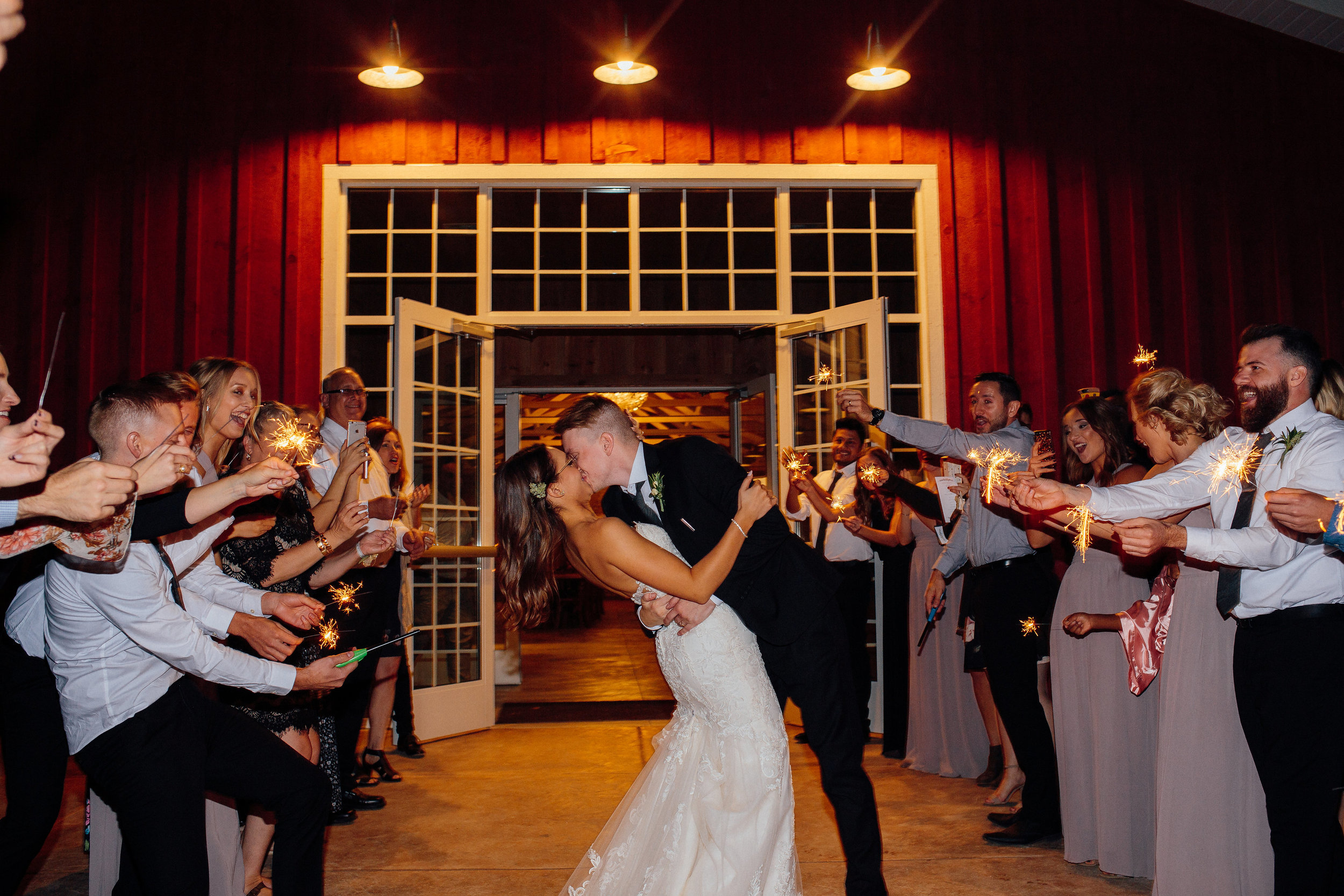 Epic wedding exit bride and groom kiss surrounded by guests in Minnesota wedding