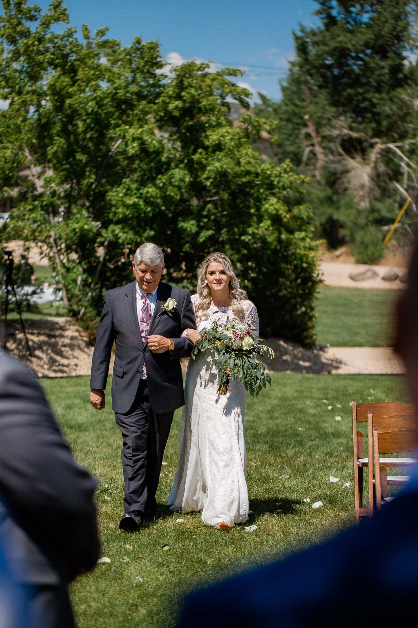 Bride and Father walking down aisle during wedding ceremony