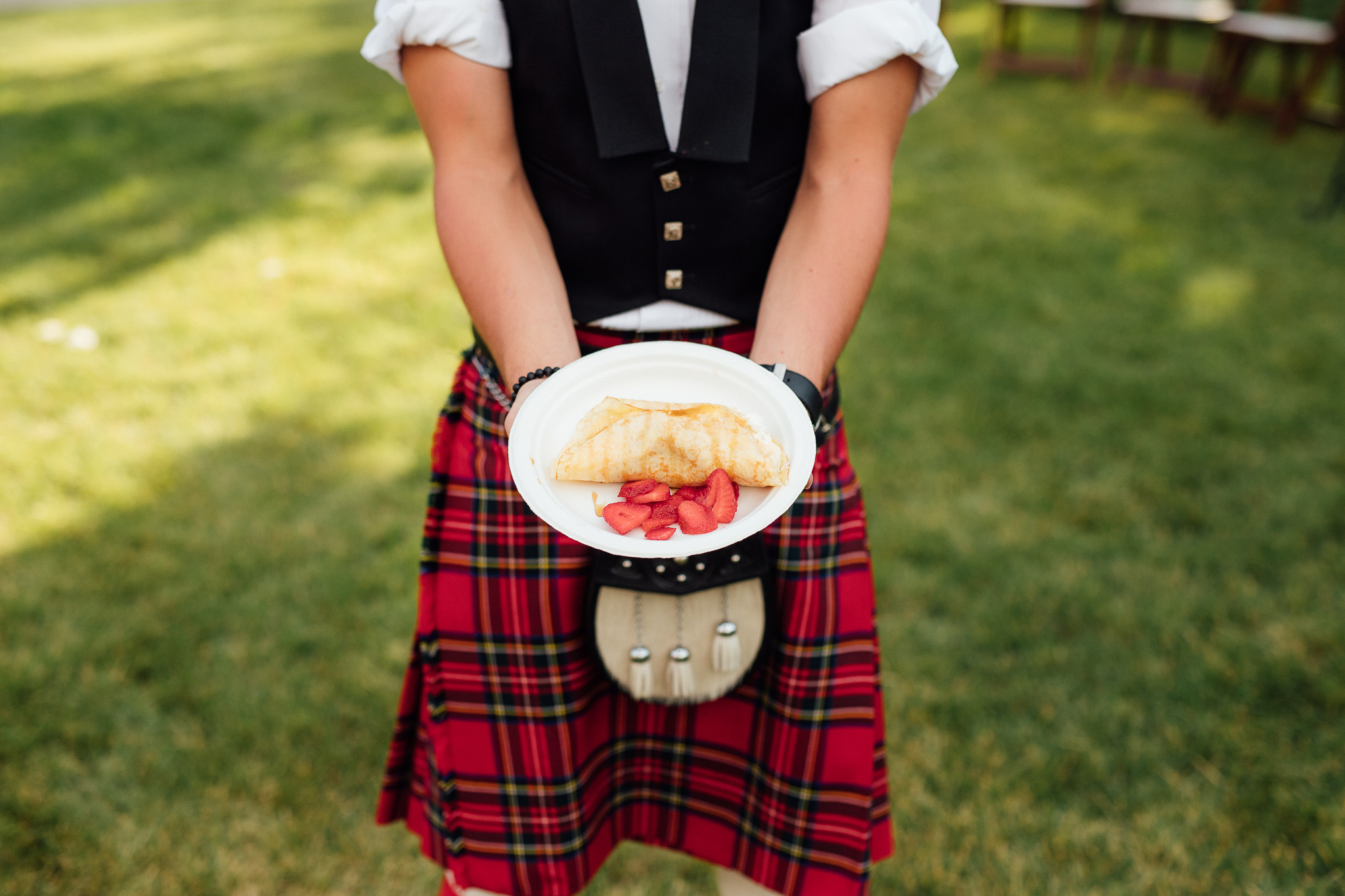 Boy holding kilt shows his crepe
