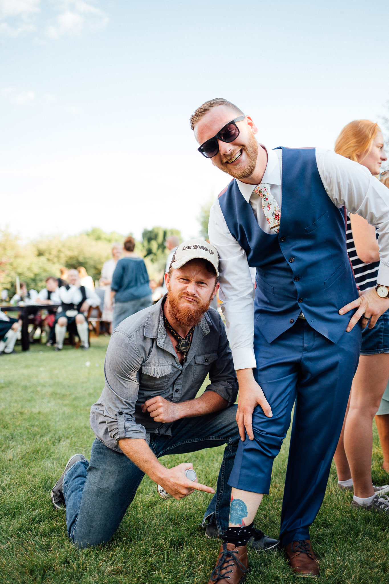 Groom and friend mingle during wedding reception
