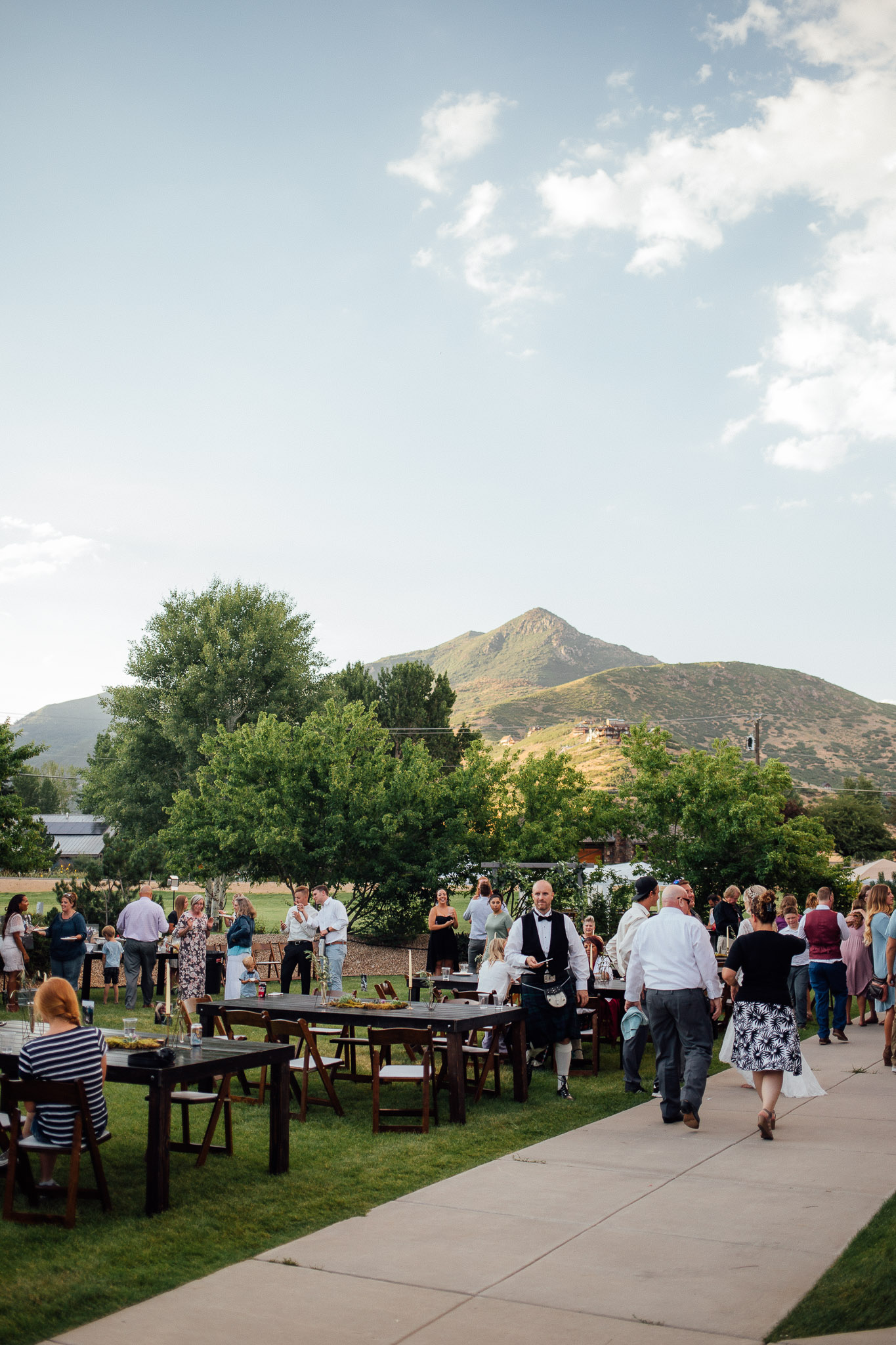 Guests dance during wedding reception with view of the Uintah Mountains