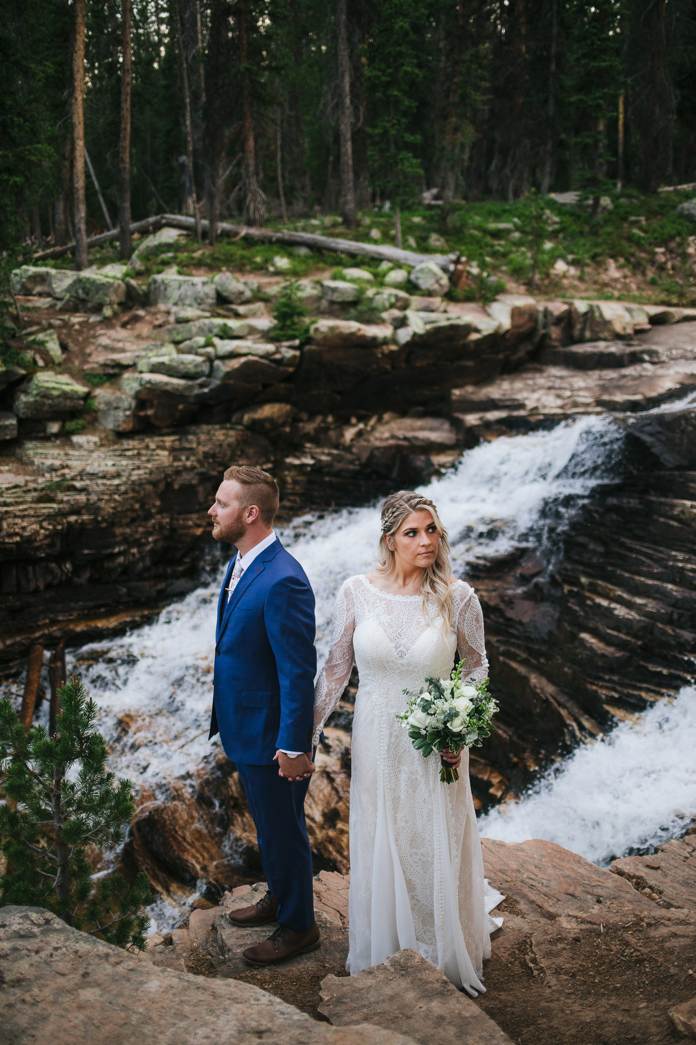 Bride and Groom pose for wedding photos at Provo Falls in the Utah Mountains
