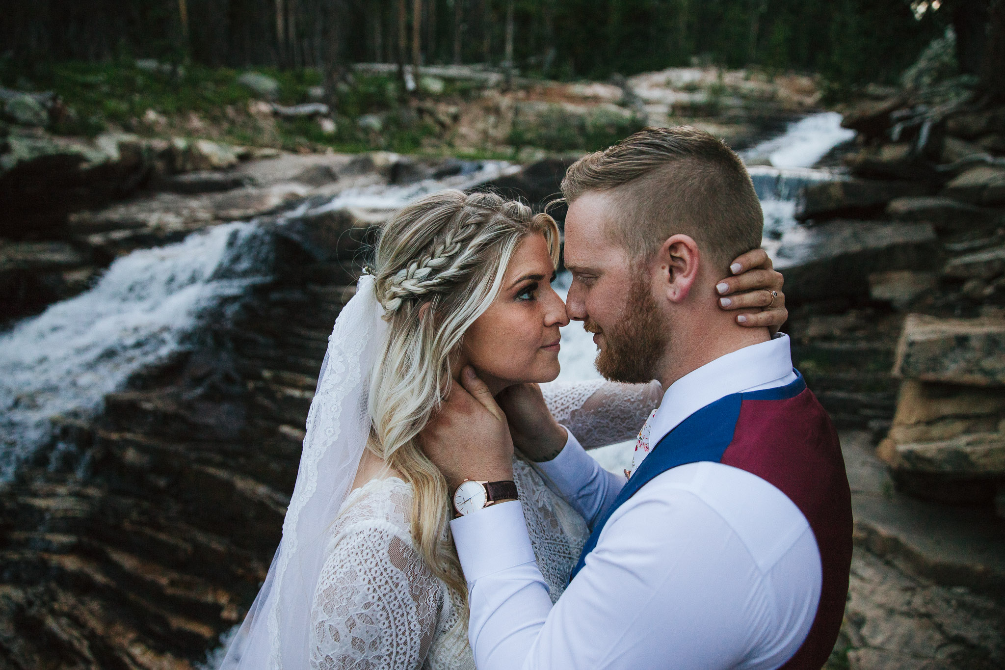 Bride and Groom pose for wedding photos at Provo Falls in the Utah Mountains