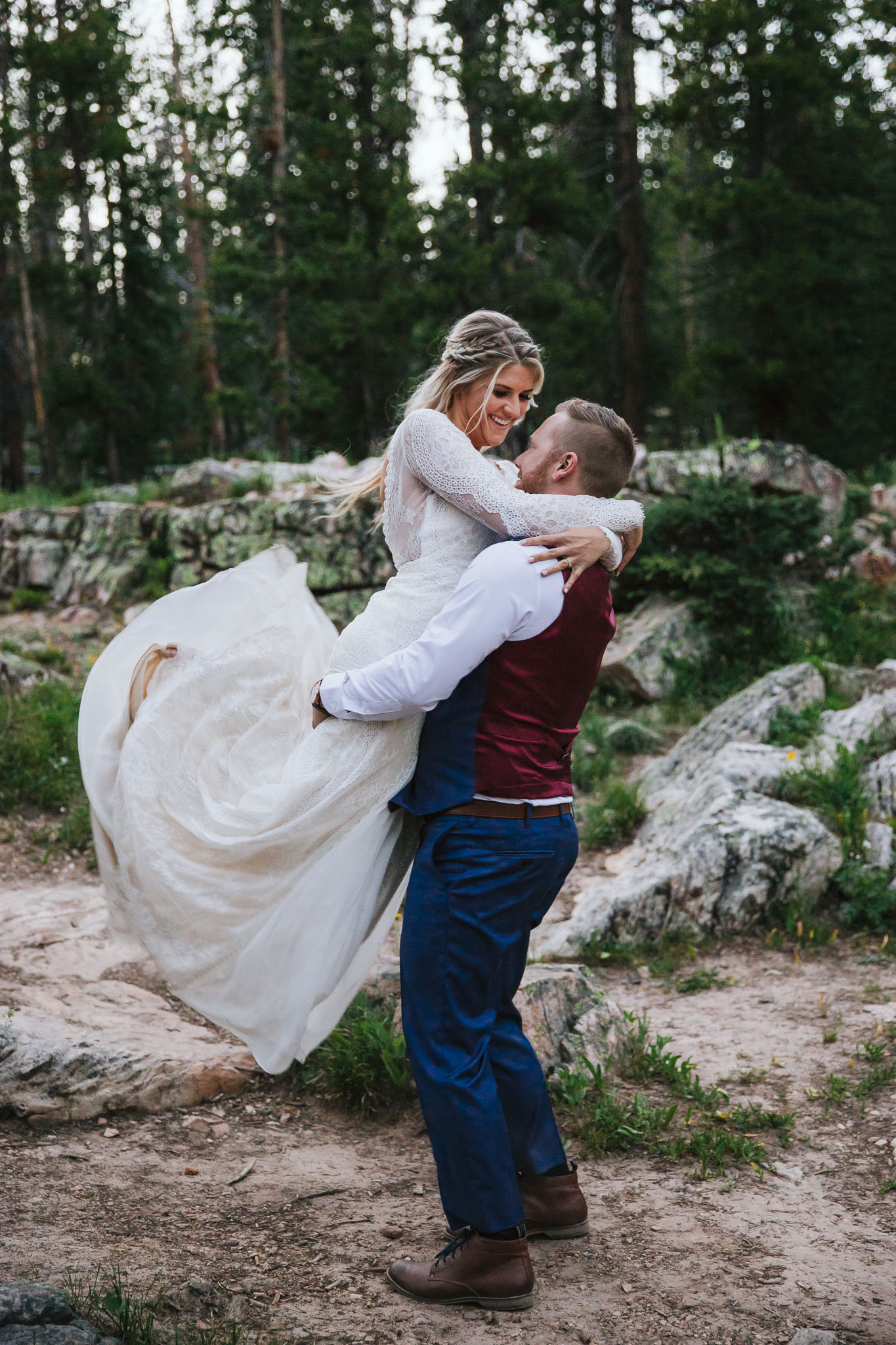 Bride and Groom pose for wedding photos at Provo Falls in the Utah Mountains