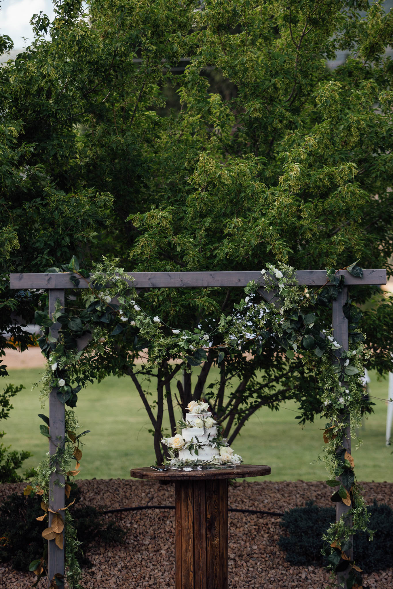 Wedding cake under arbor