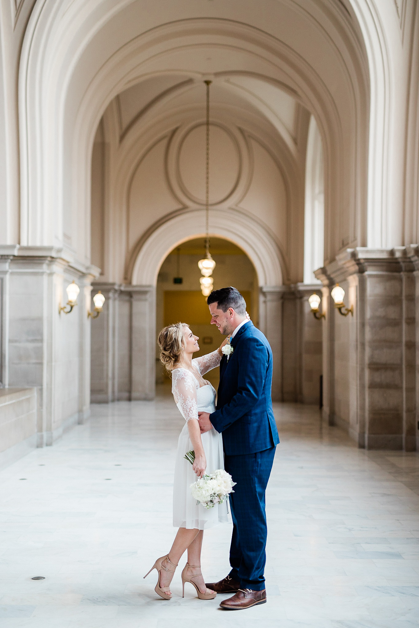 Bride and Groom posing for wedding portraits in San Francisco City Hall