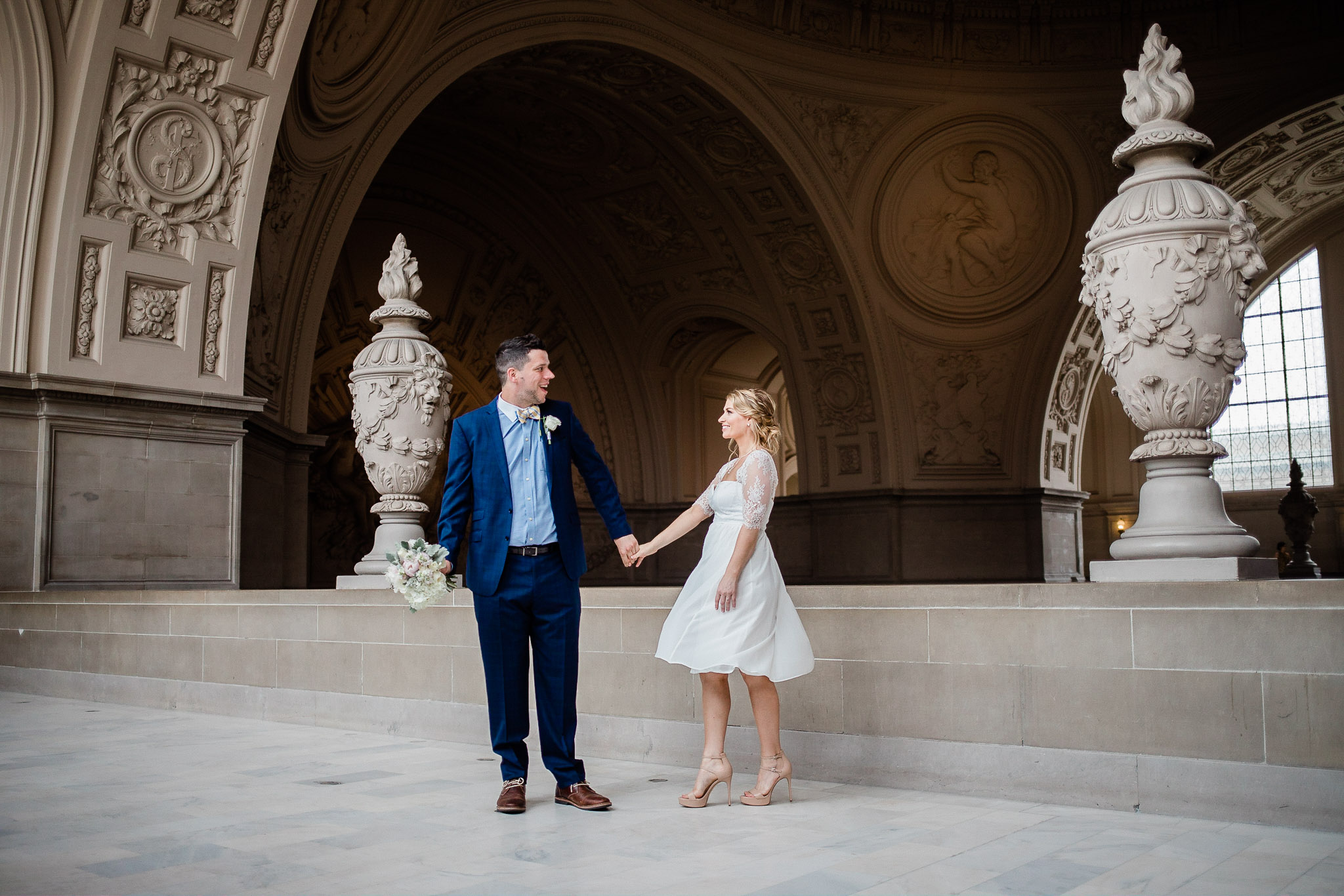 Bride and Groom posing for wedding portraits in San Francisco City Hall