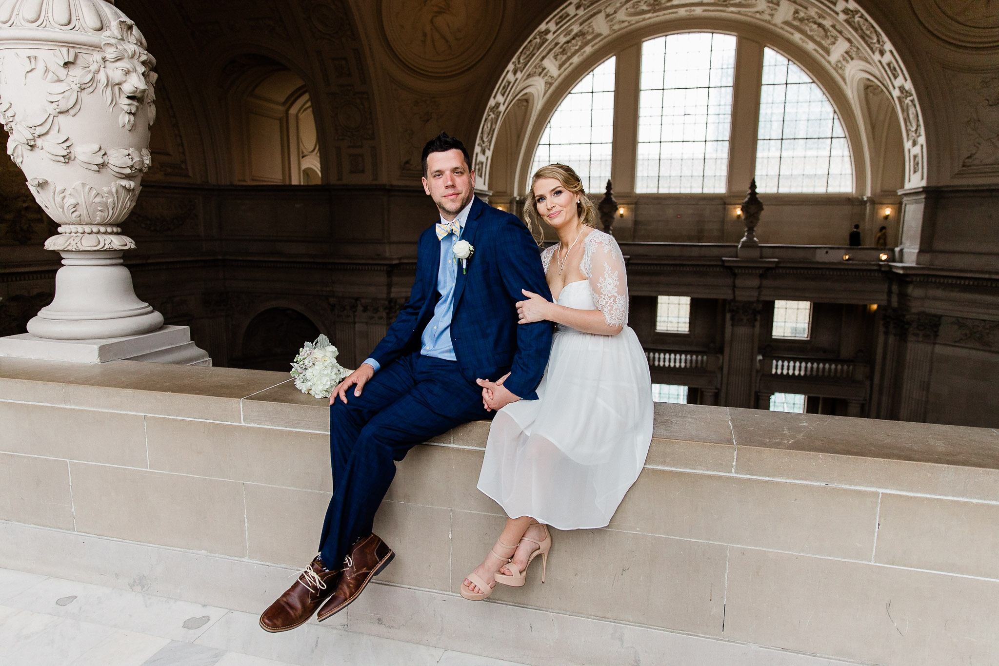 Bride and Groom posing for wedding portraits in San Francisco City Hall