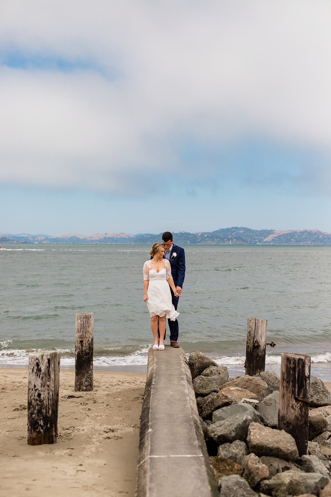 Bride and Groom pose for wedding photos near the Golden gate bridge