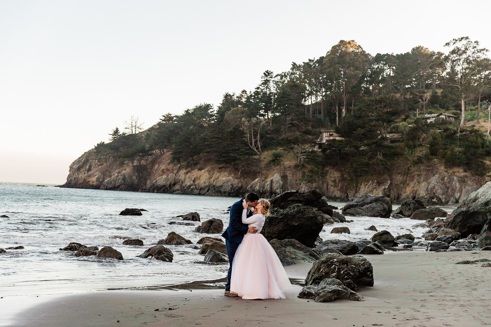 Bride and Groom pose for wedding photos on the beach near San Francisco