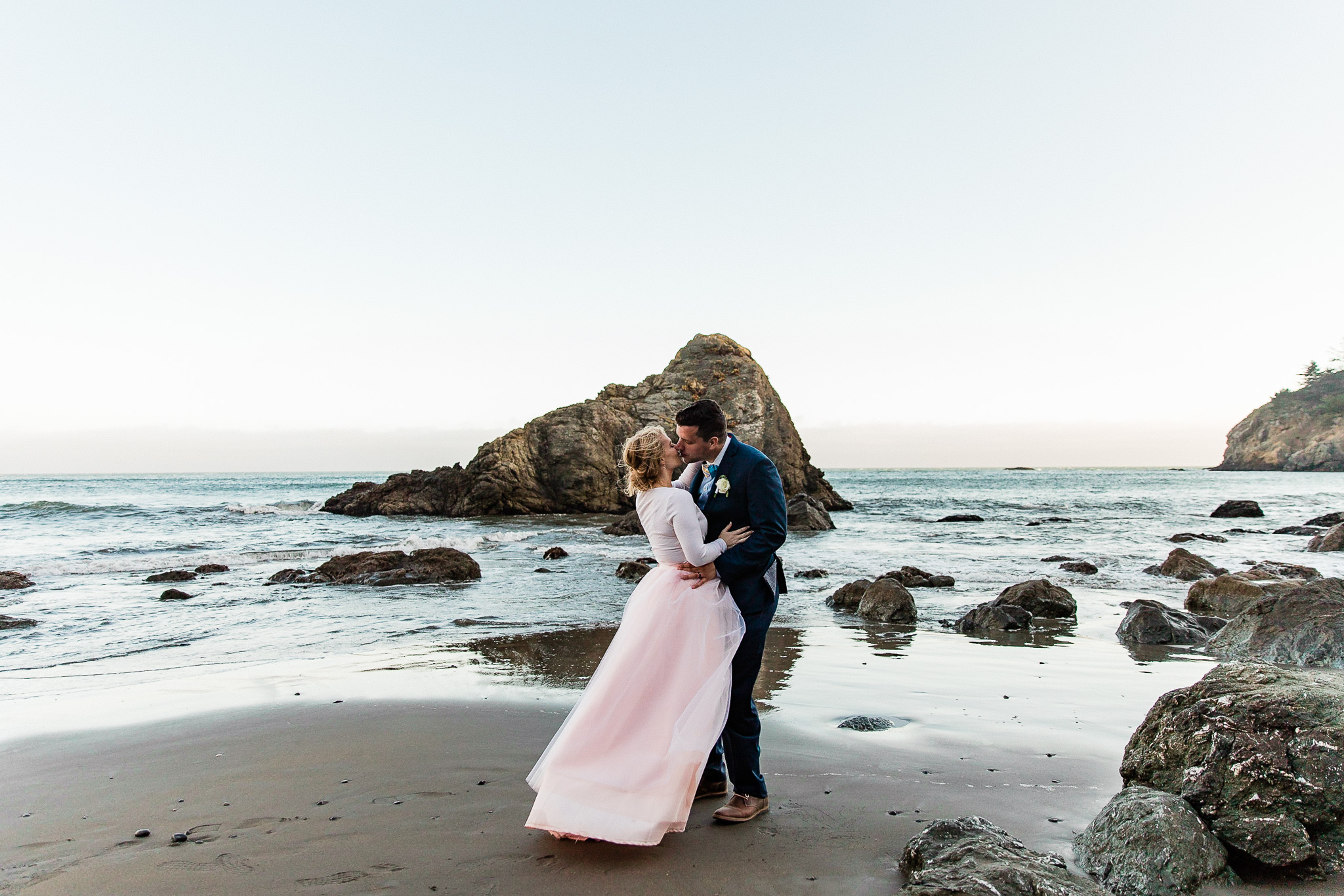 Bride and Groom pose for wedding photos on the beach near San Francisco