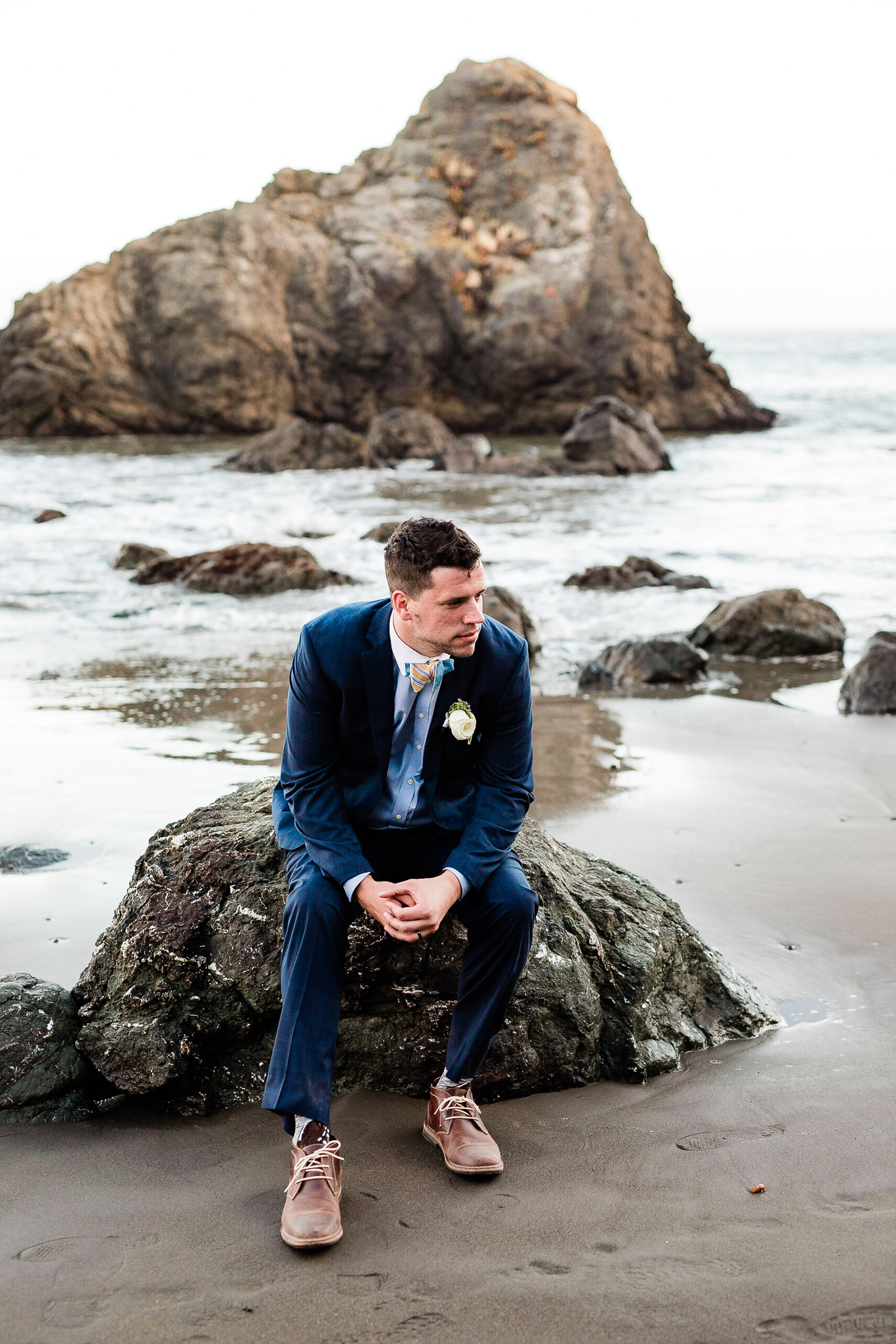 Groom pose for wedding photos on the beach near San Francisco