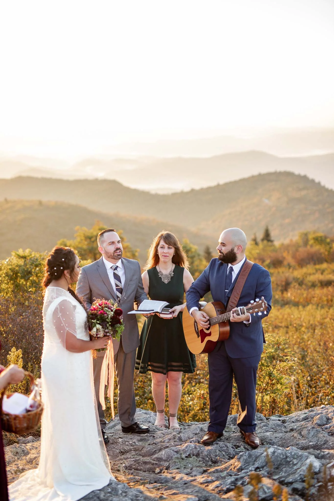 Bride and groom lead worship song at their mountain wedding ceremony on Black Balsam Knob on the Blue Ridge Parkway in Asheville North Carolina