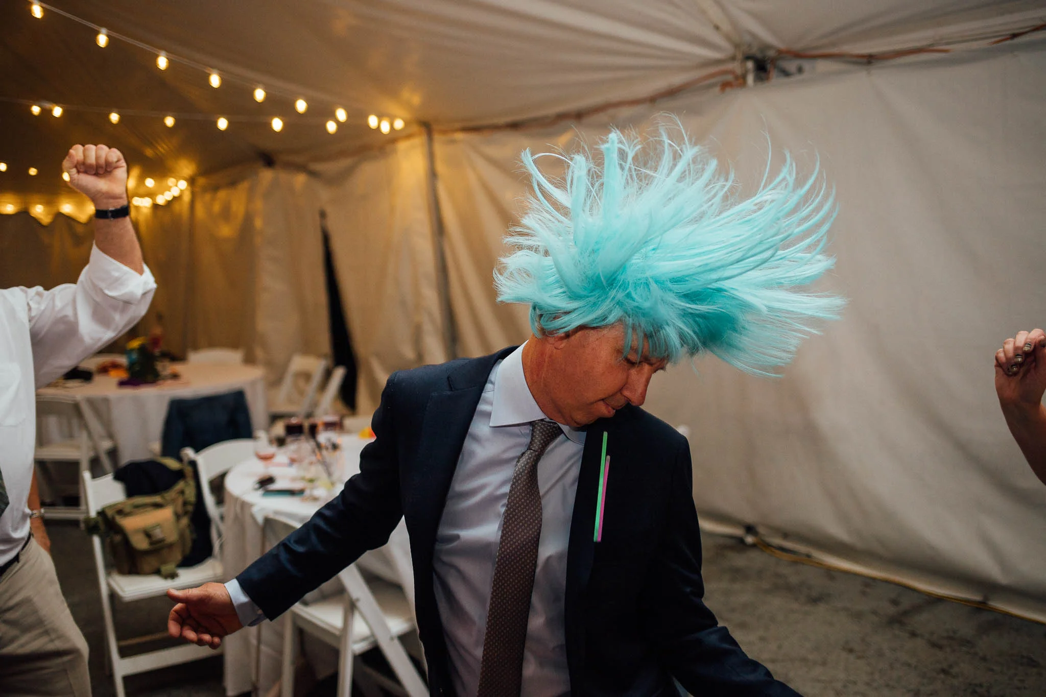 Wedding guest dancing with blue wig at wedding reception at Ten Peak Crested Butte Colorado