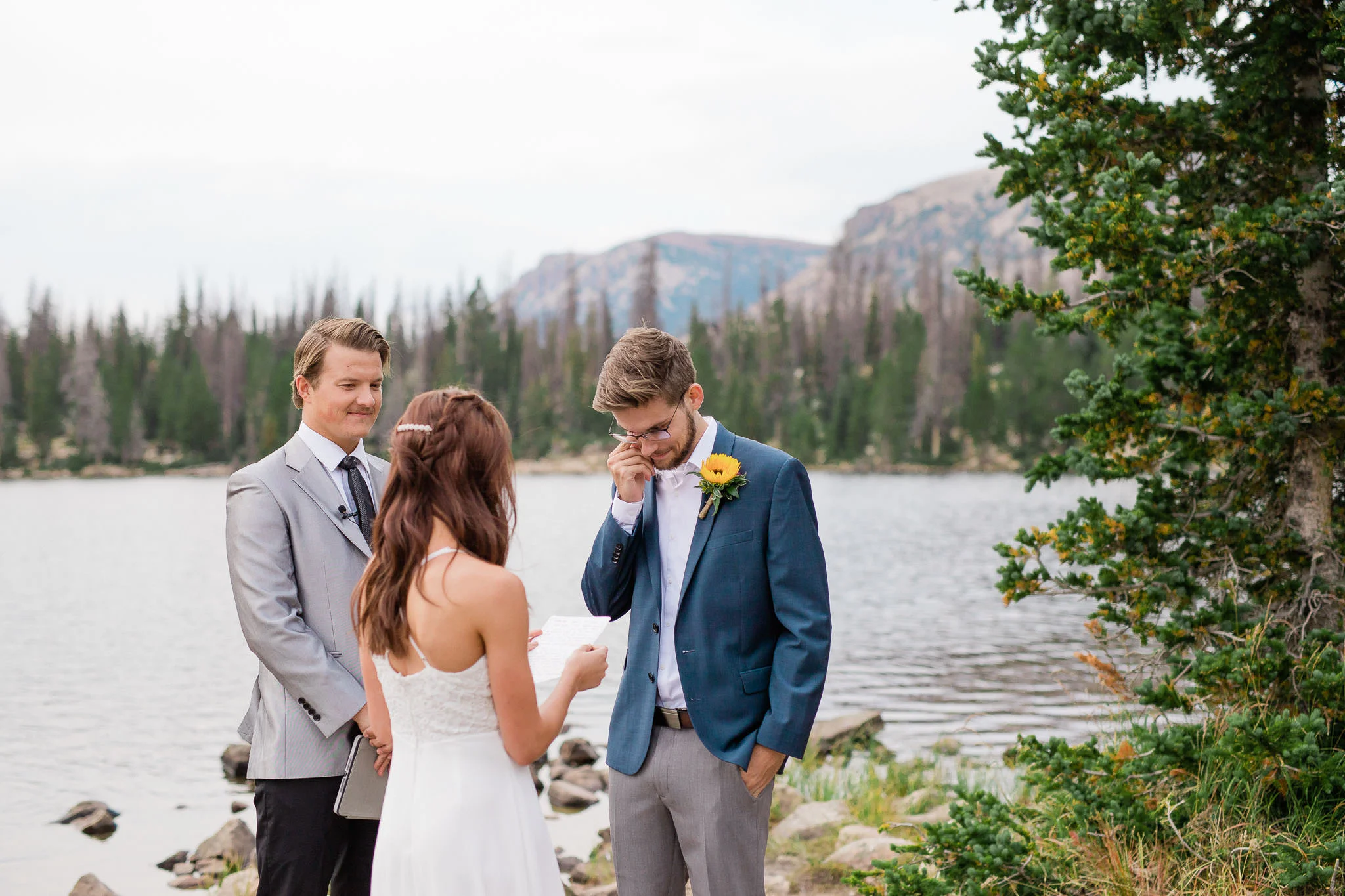 Groom wipes away a tear during Utah mountain elopement ceremony