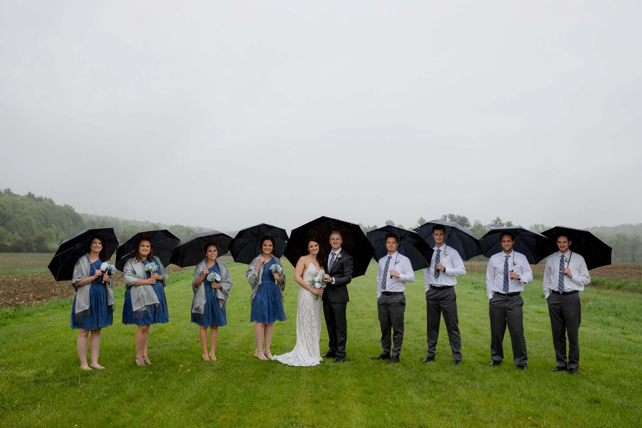 Bridal party with umbrellas rainy day wedding Upstate New York