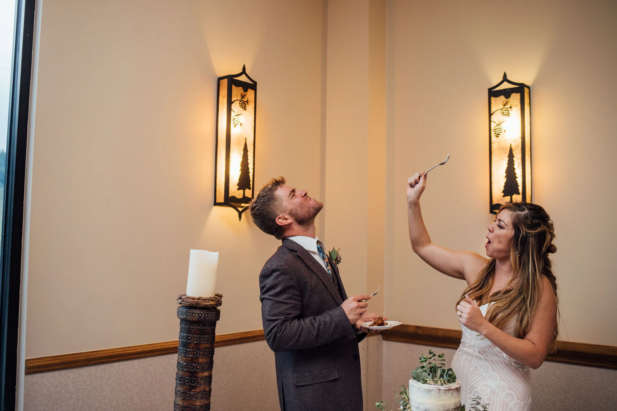 Bride and groom cutting the cake Colorado wedding photographer winter park