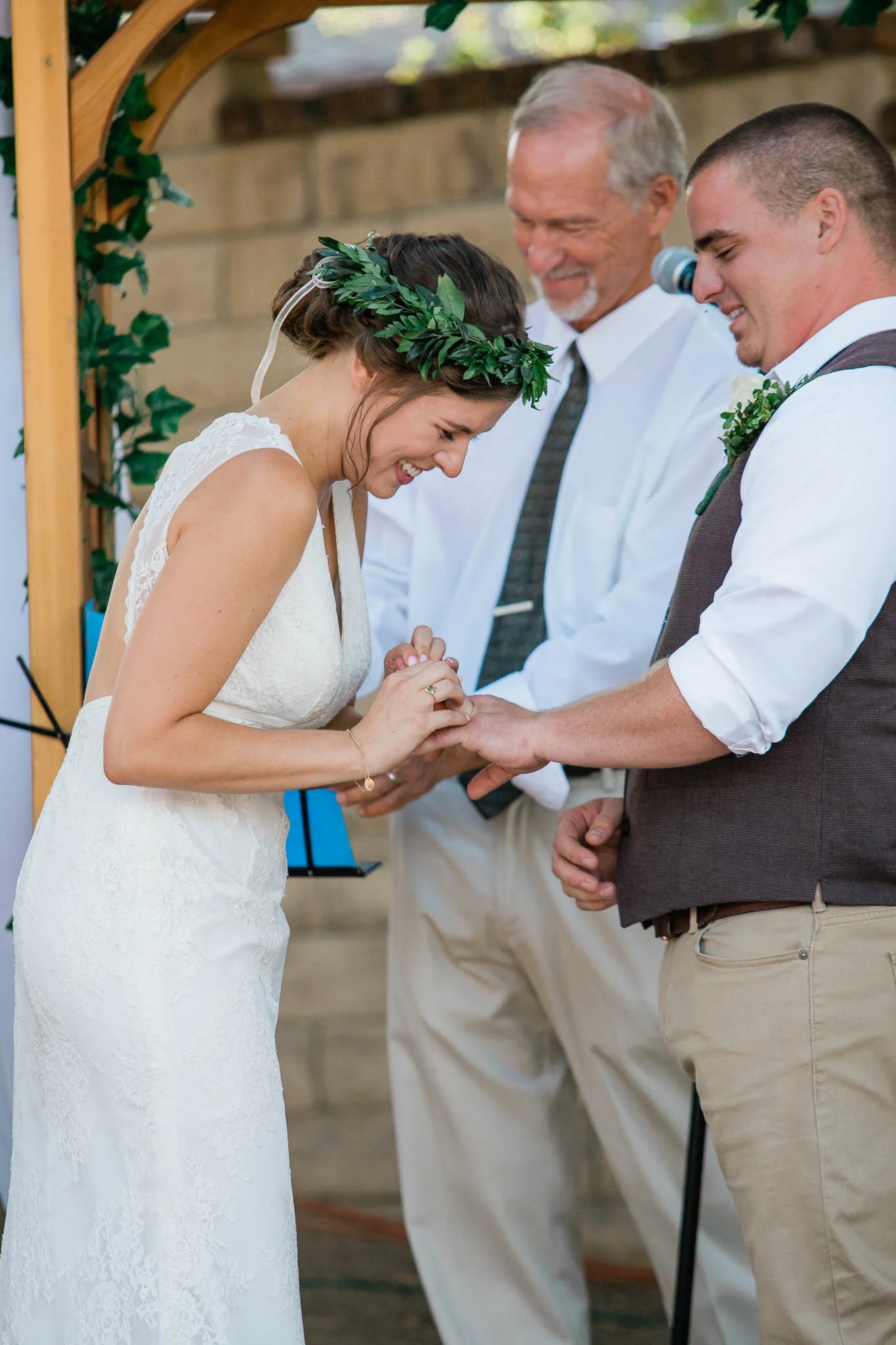 Bride placing ring on groom's finger wedding ceremony in Pasadena California