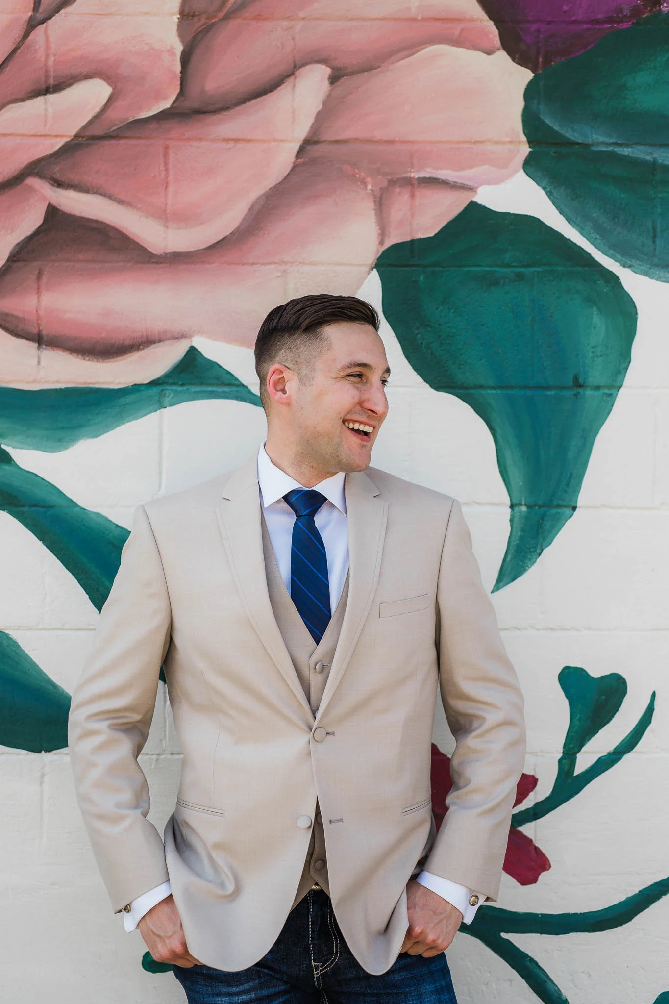 Groom portrait in front of mural in Waco Texas