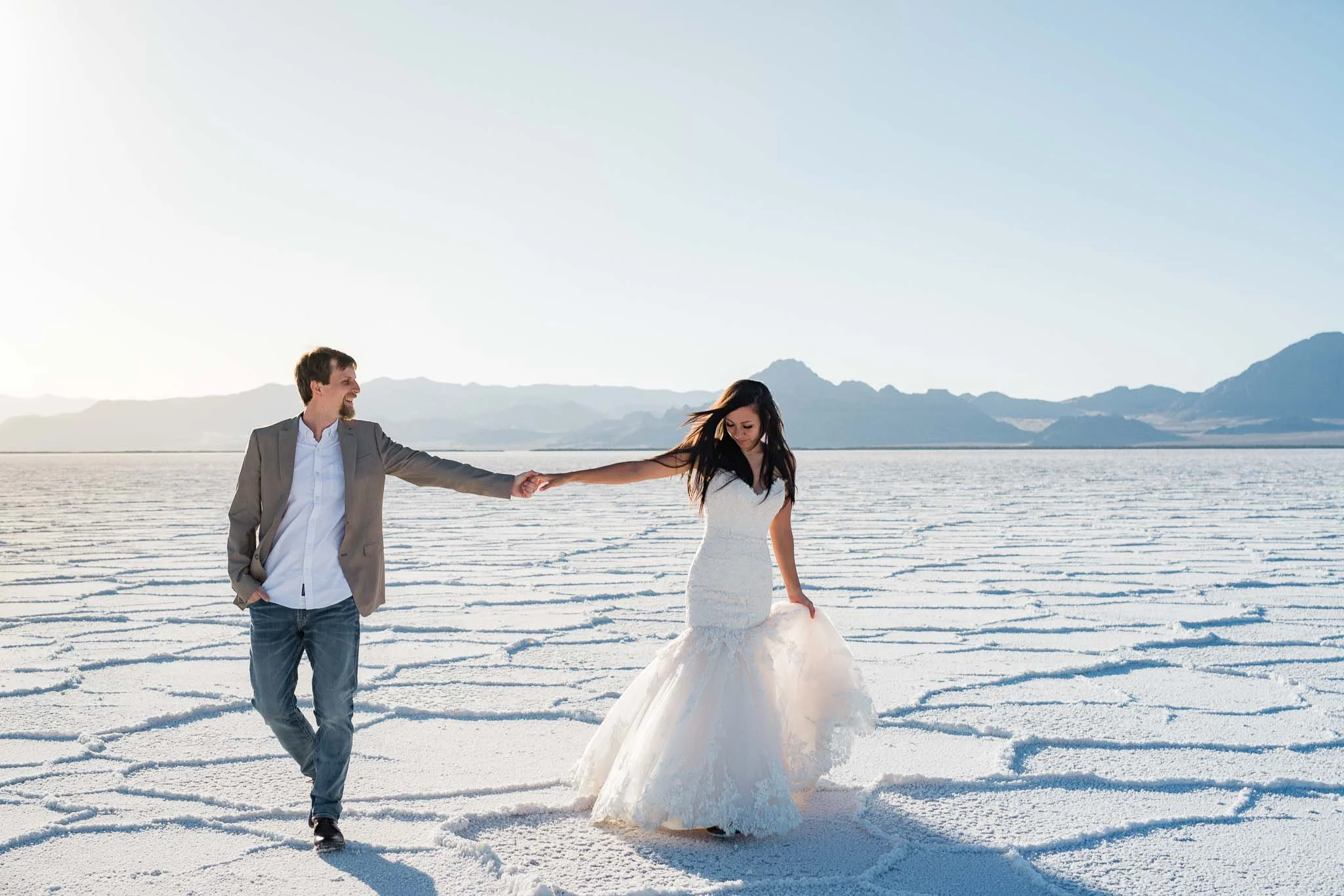 Groom holds bride at the Bonneville Salt Flats, Utah