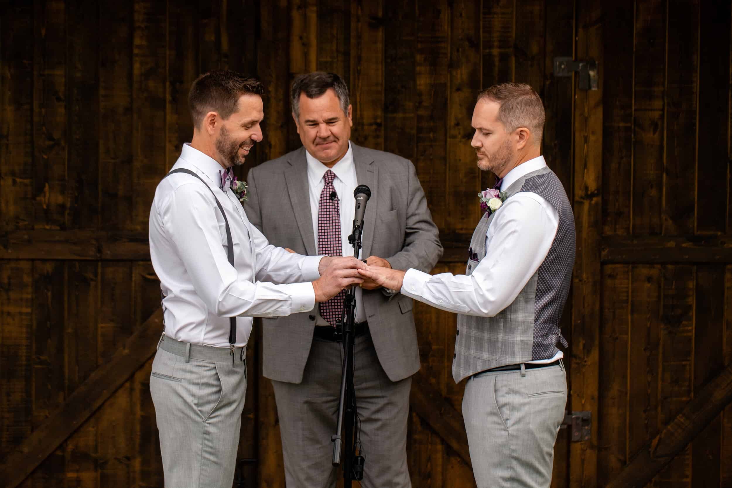 Two grooms exchange rings during their Destination Wedding in Utah