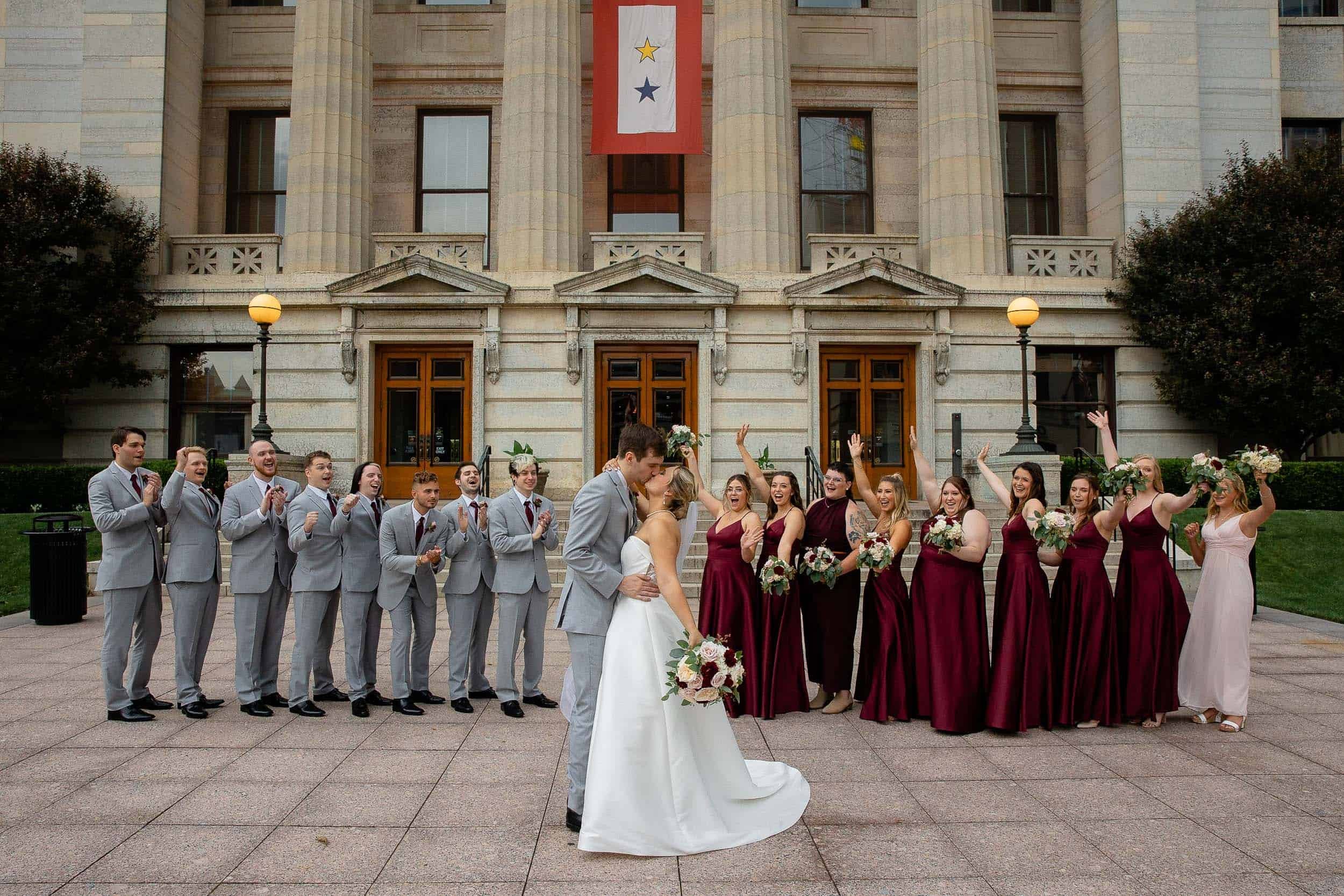 Bride and groom kiss while bridesmaids and groomsmen kiss Destination Wedding Photographer
