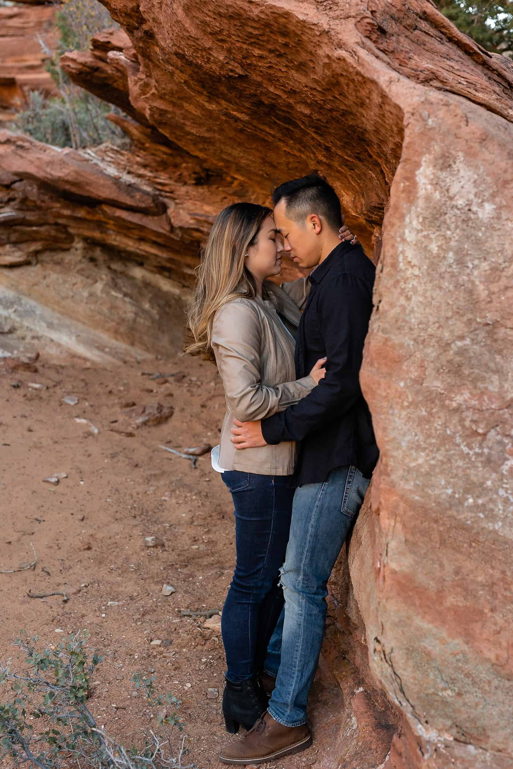 Asian couple snuggle during their Zion National Park Engagement Photoshoot Utah