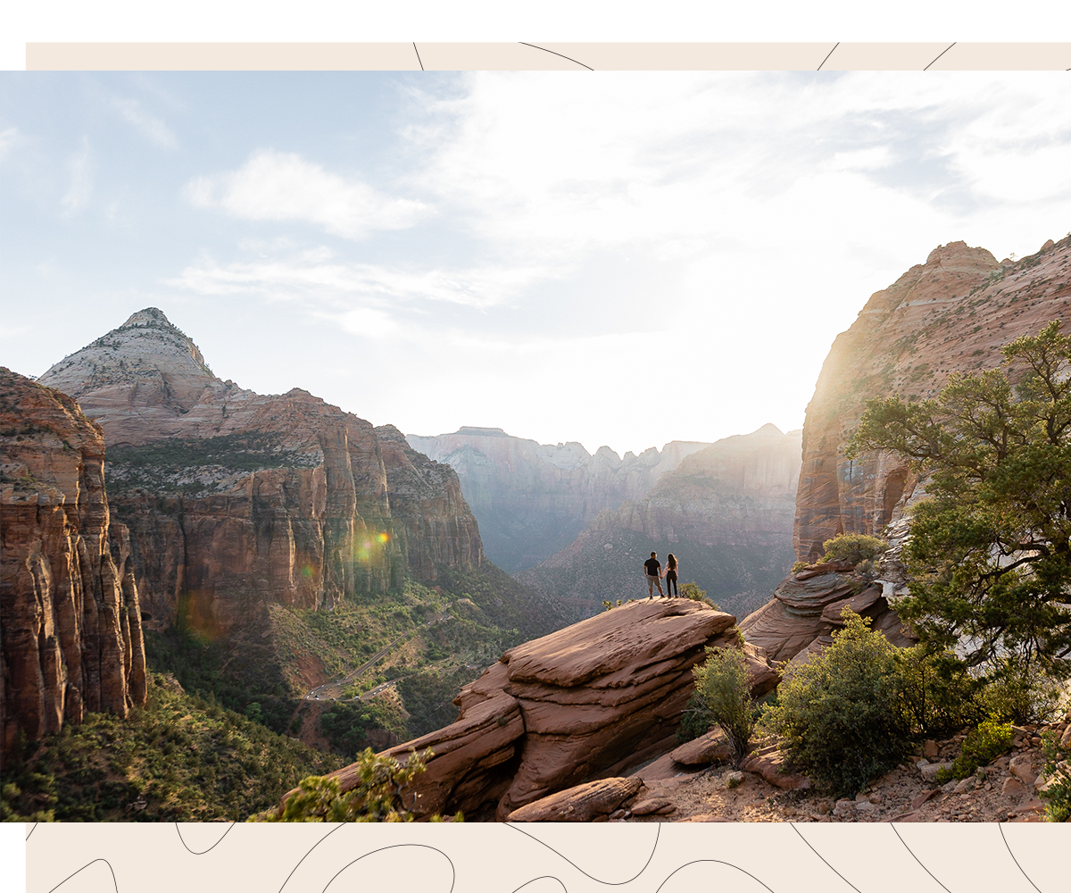 Epic wide landscape of Zion National Park with a couple small in the frame after their surprise proposal