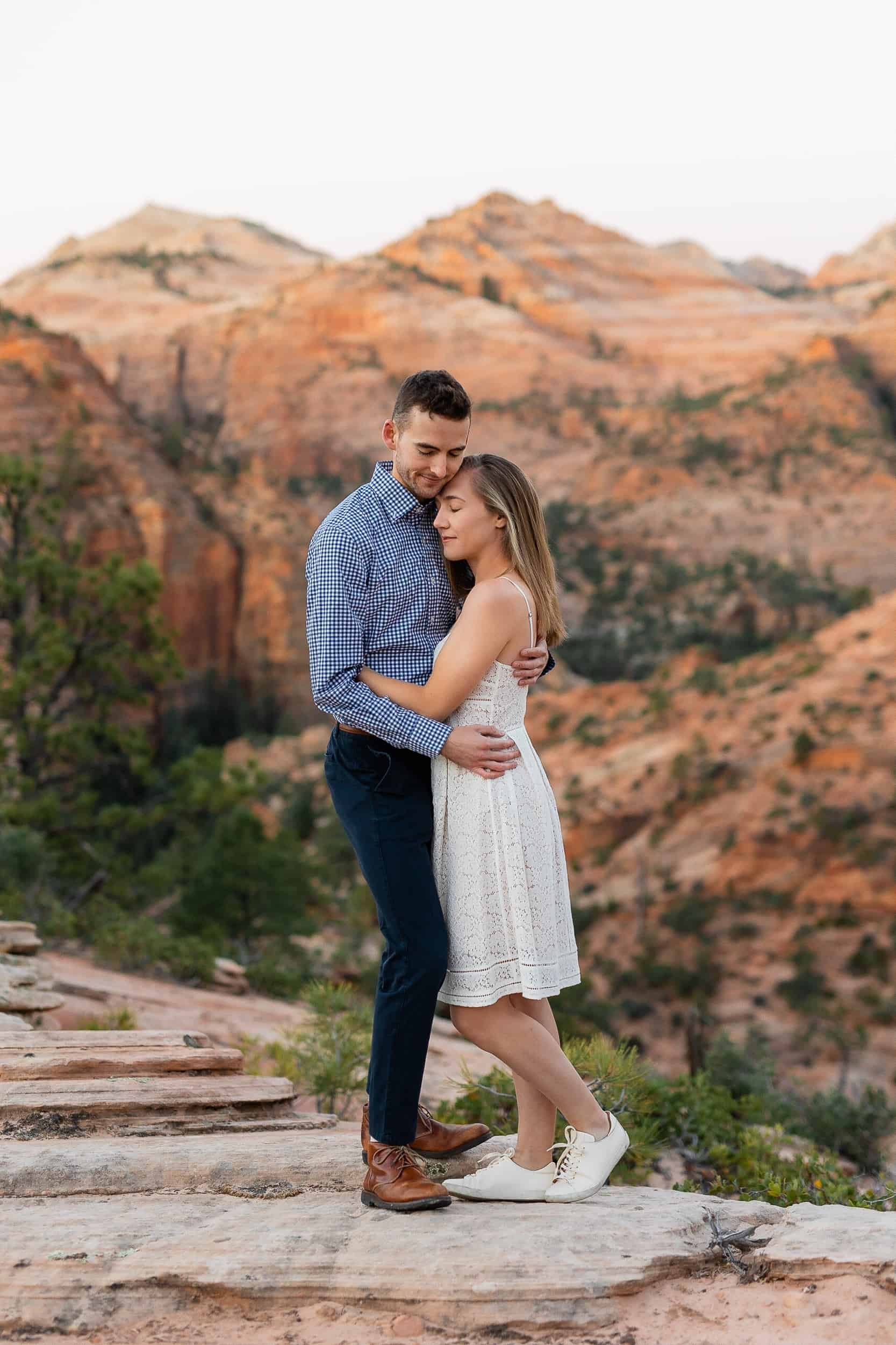 Couple hold each other close during their engagement photoshoot in Zion National Park