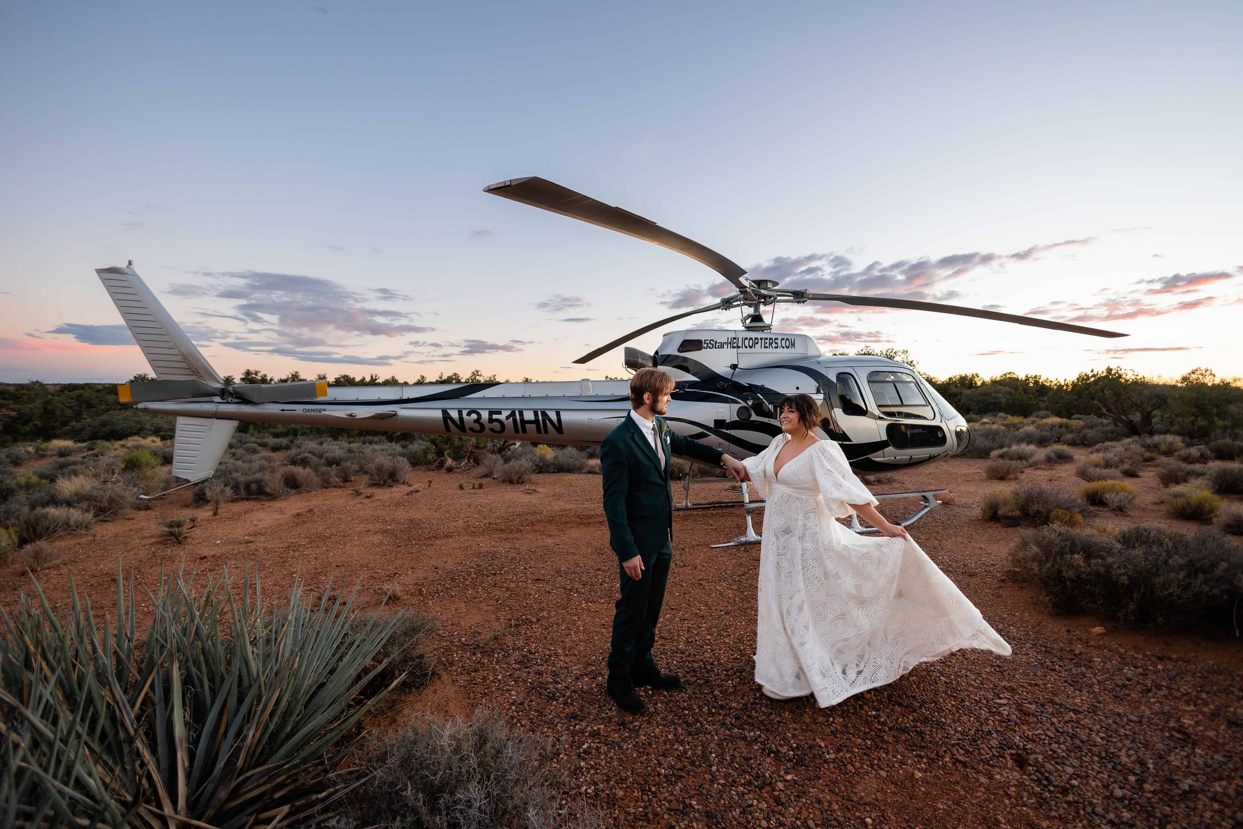 Bride and groom dance in front of a helicopter near Zion National  Park