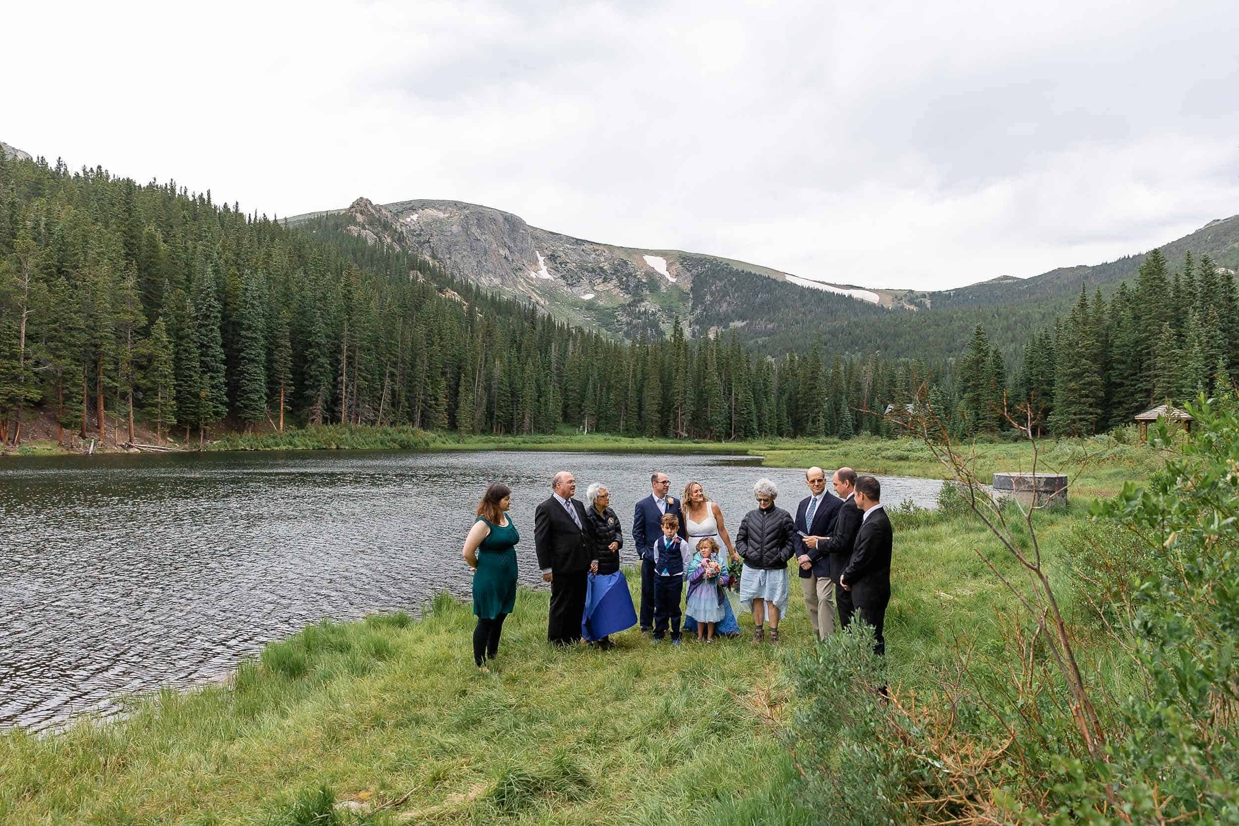 Couple surrounded by their family during their elopement ceremony in the mountains in Colorado