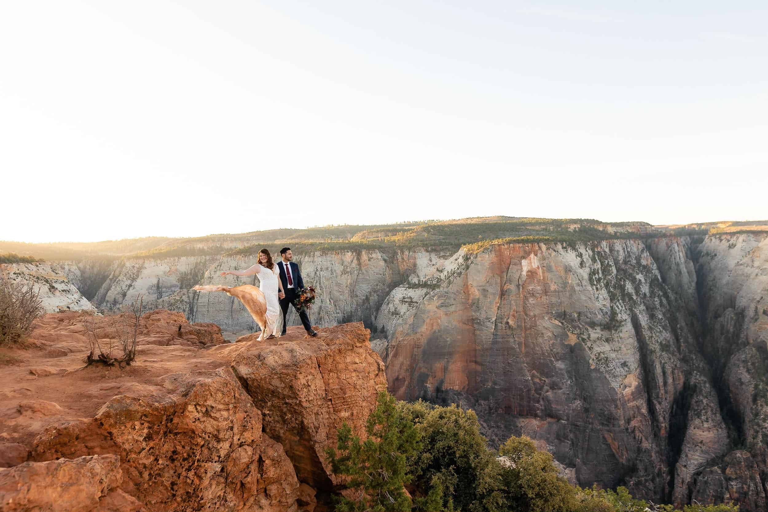 Bride tosses her dress train standing by her groom during their Zion National Park Elopement