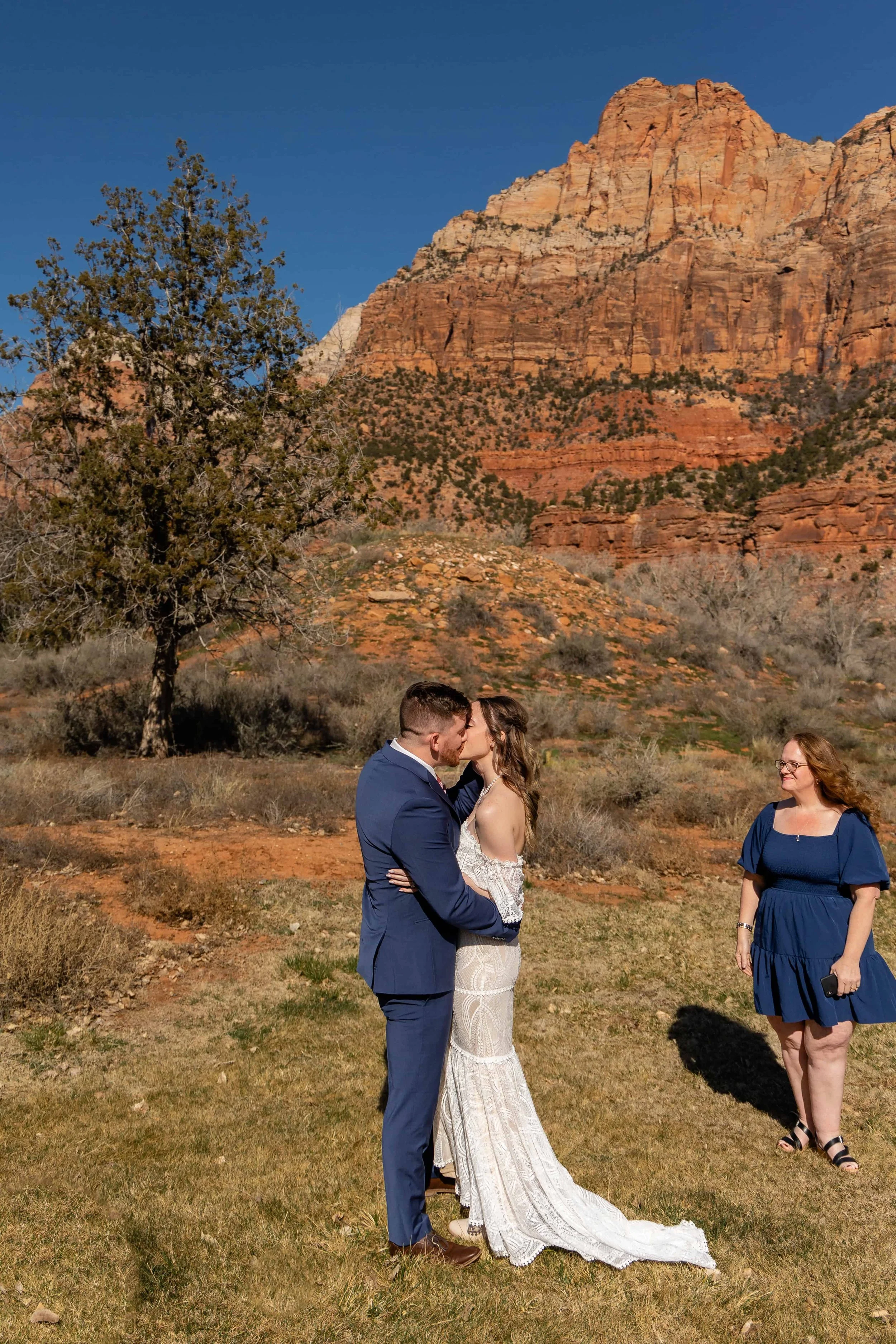 bride and groom kiss at the end of wedding ceremony zion