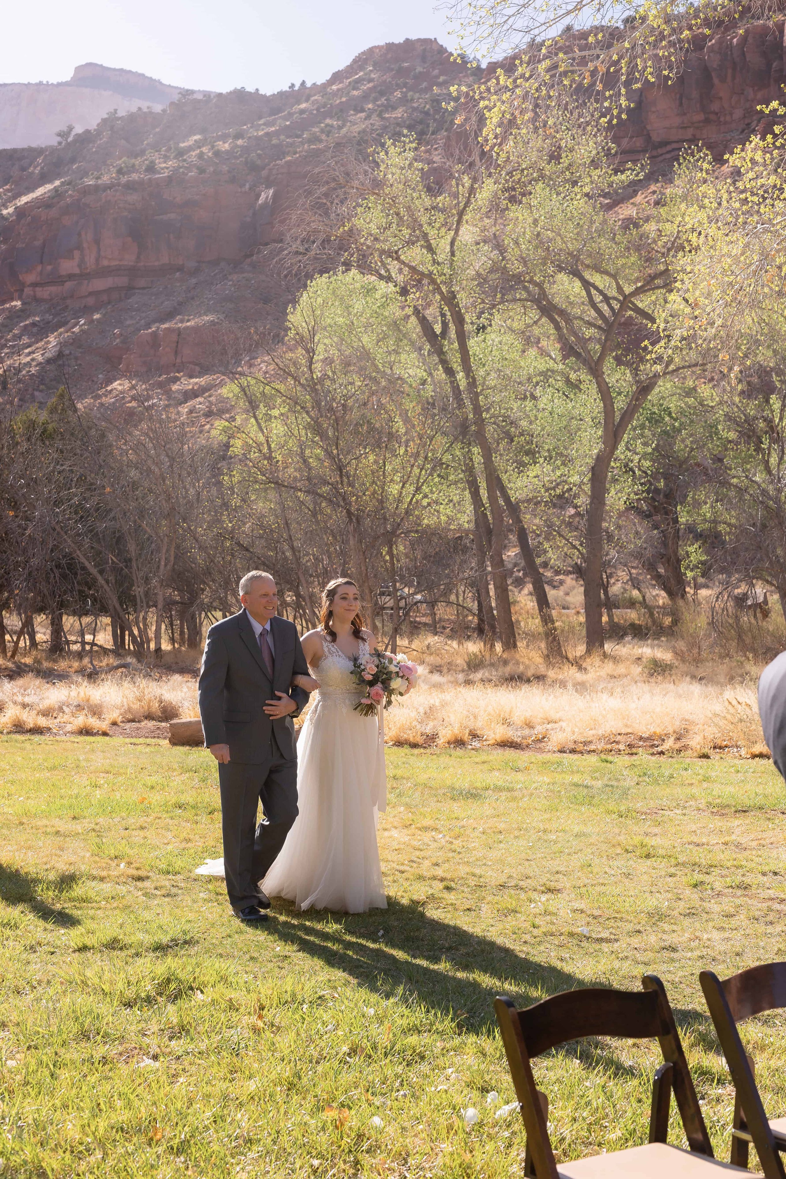 bride enters ceremony with her father zion nature center