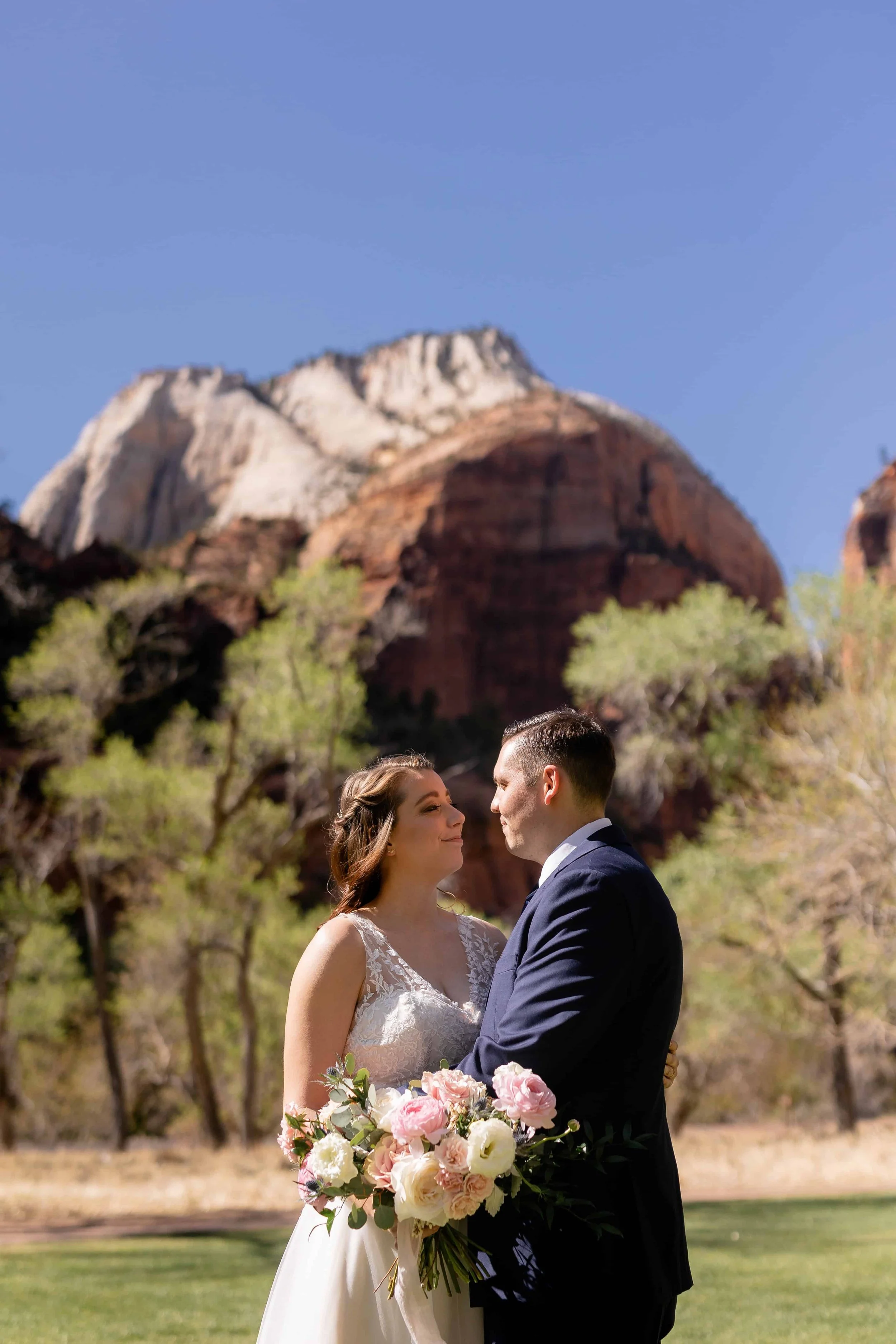 bride and groom pose for portraits before wedding ceremony