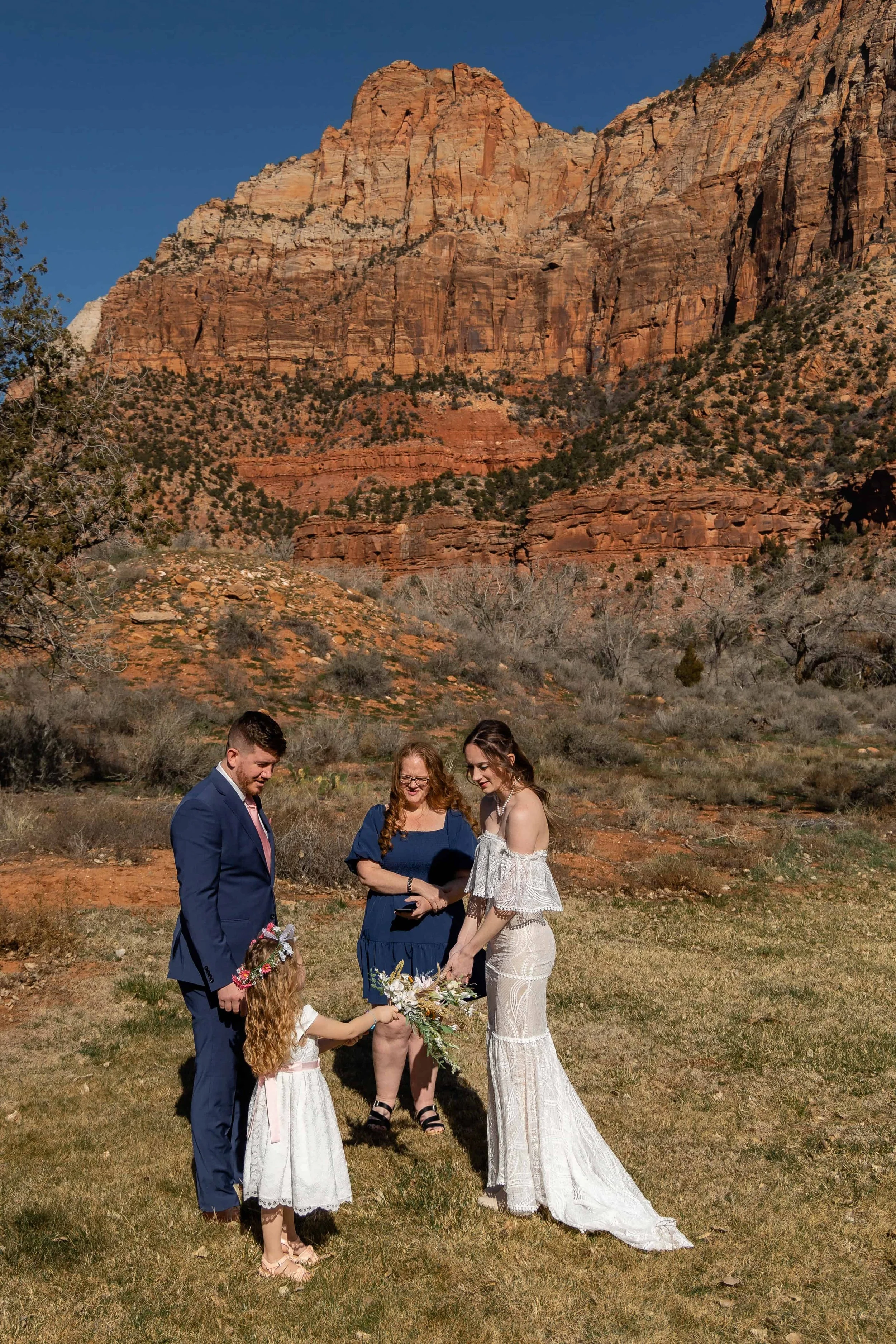 flower girl gives flowers to bride during wedding ceremony