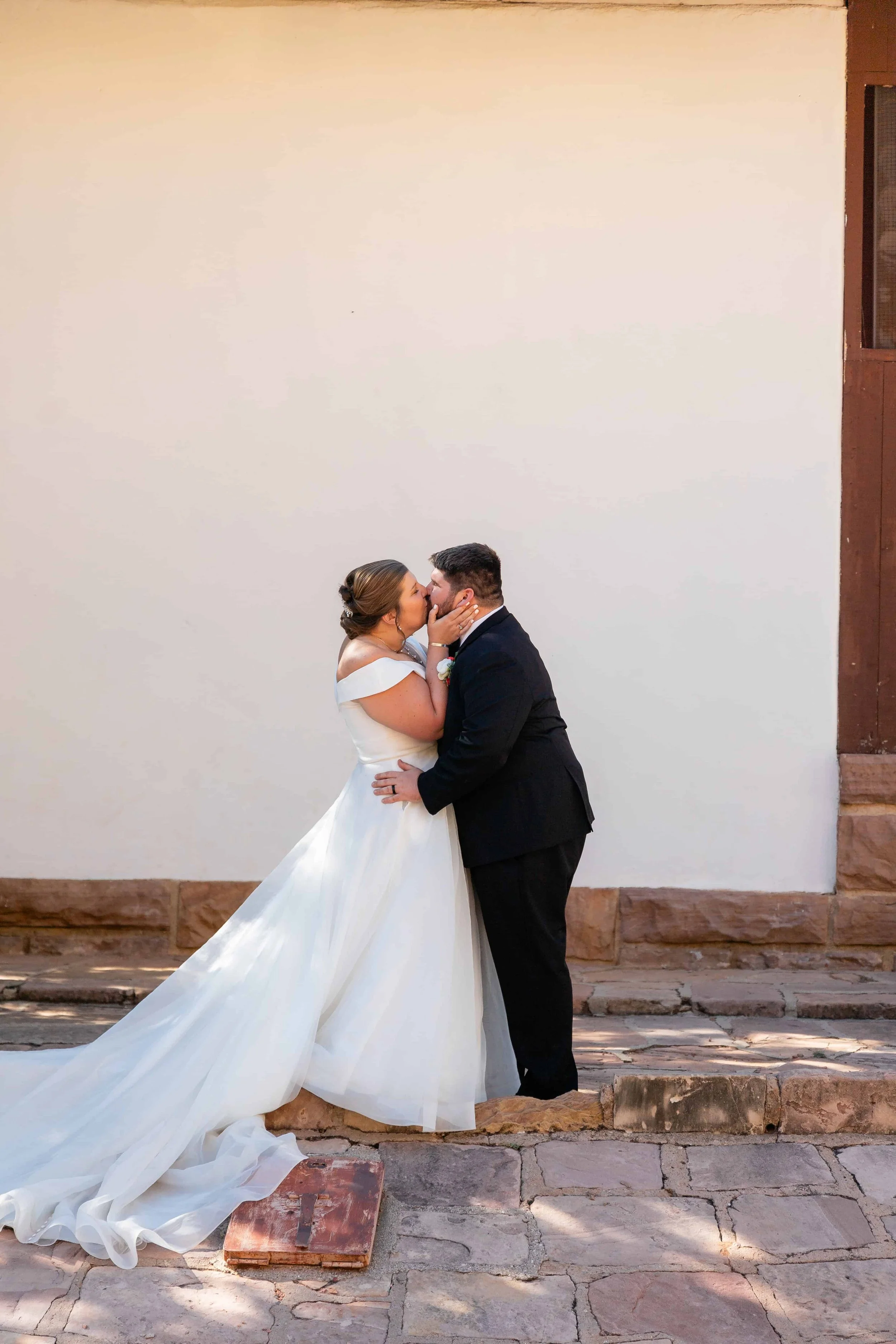 Bride and groom kiss at zion amphitheater wedding ceremony