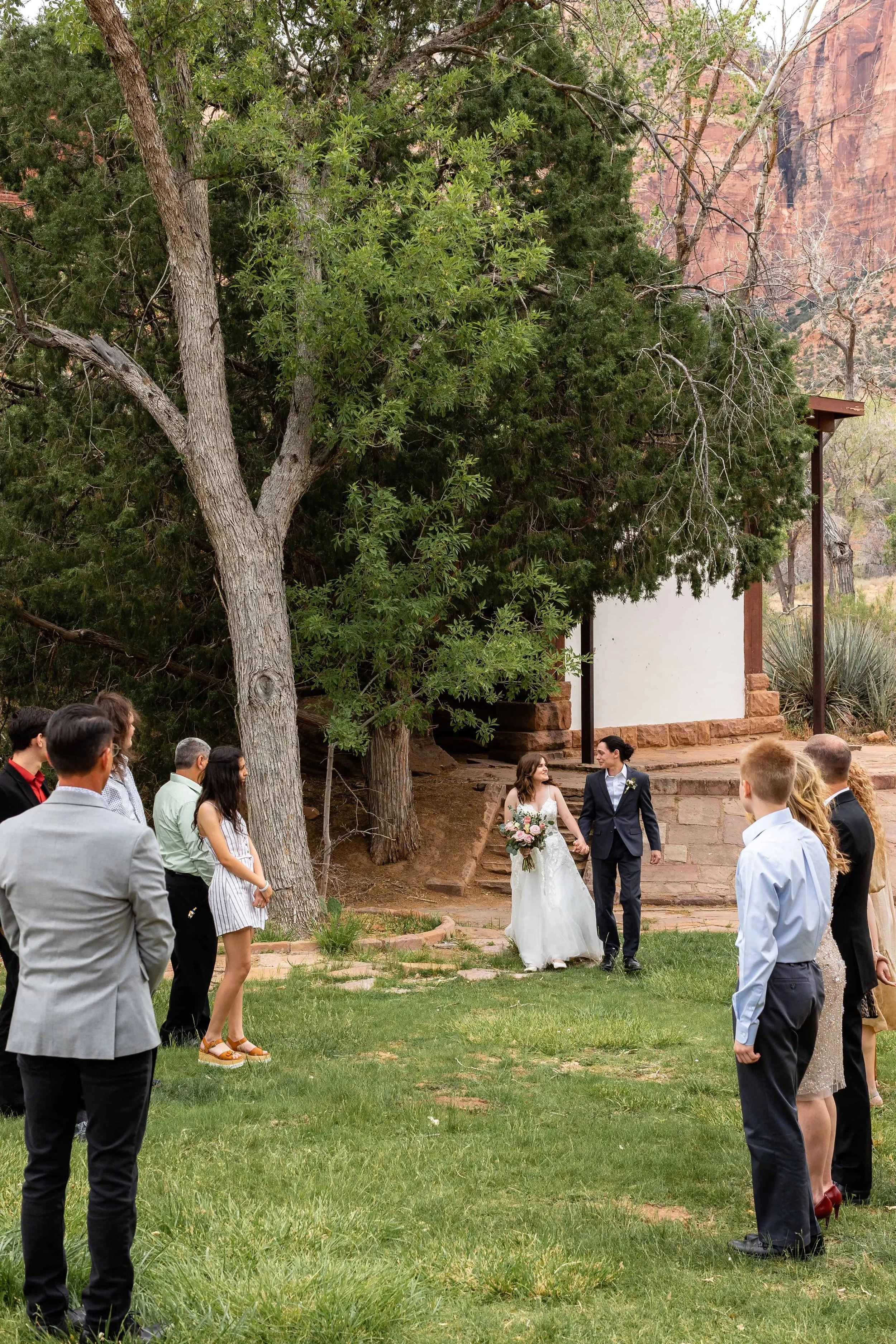Bride and groom walk together into south campground amphitheater ceremony