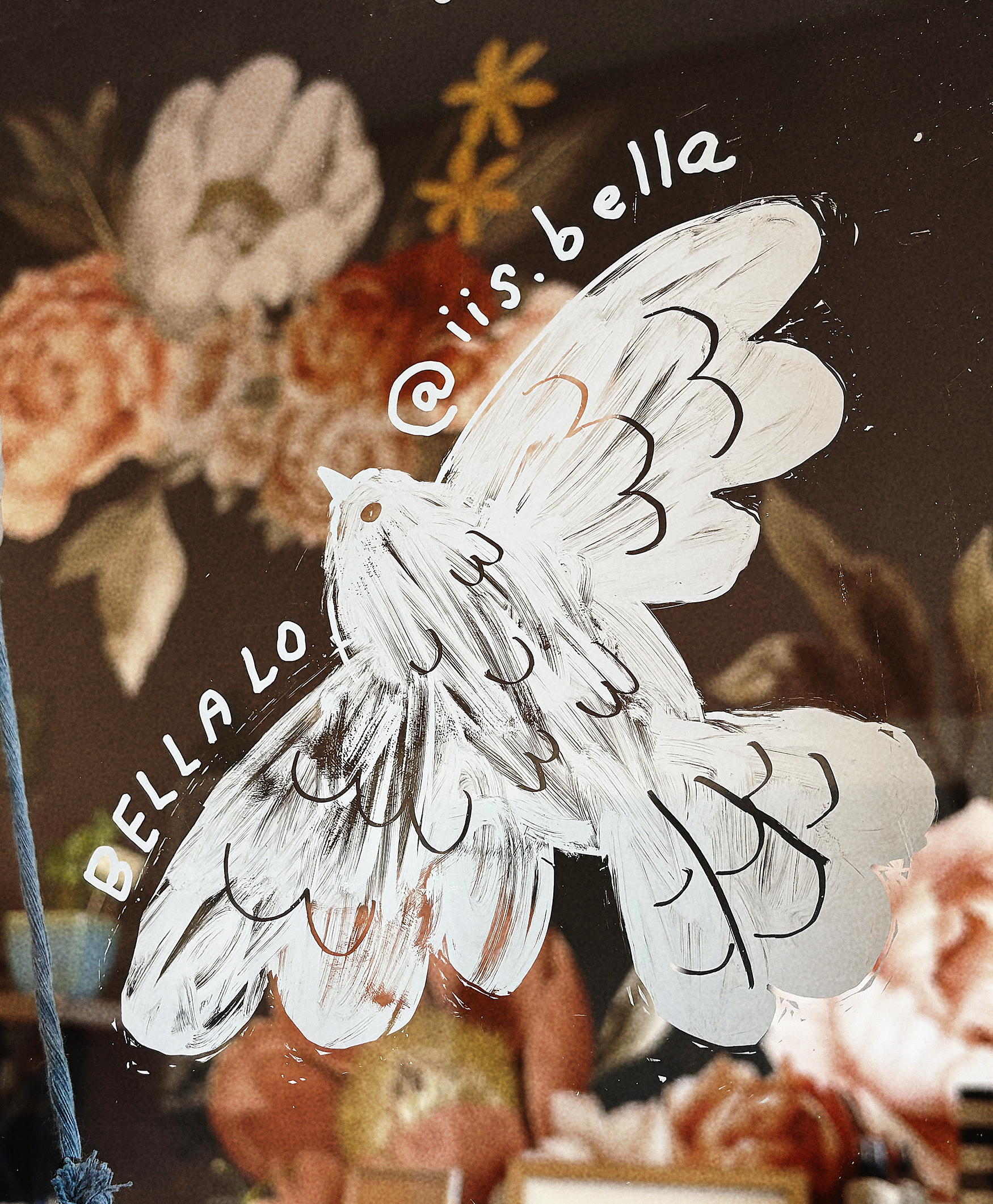 Hand-painted white bird on glass door.