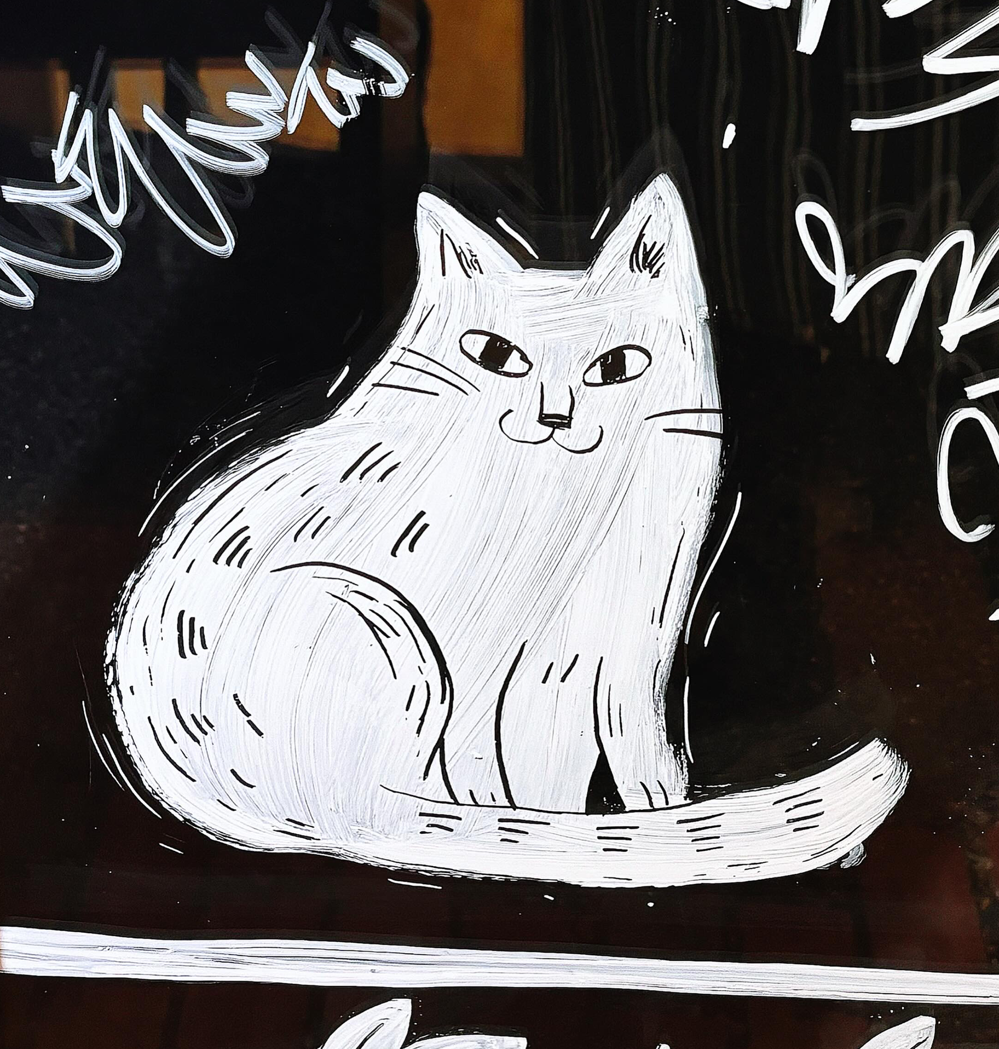 Hand-painted cat on glass window.
