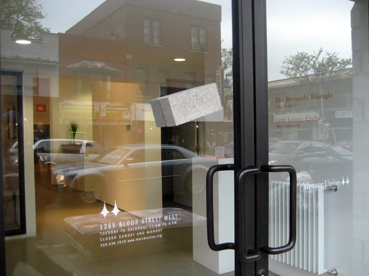 Narcissus Stops To Look At His Dumb Reflection , dimensions variable (2 bricks = 2.25" x 3.5" x 8.5" each), two bricks attached with silicon to either side of gallery storefront window, 2010