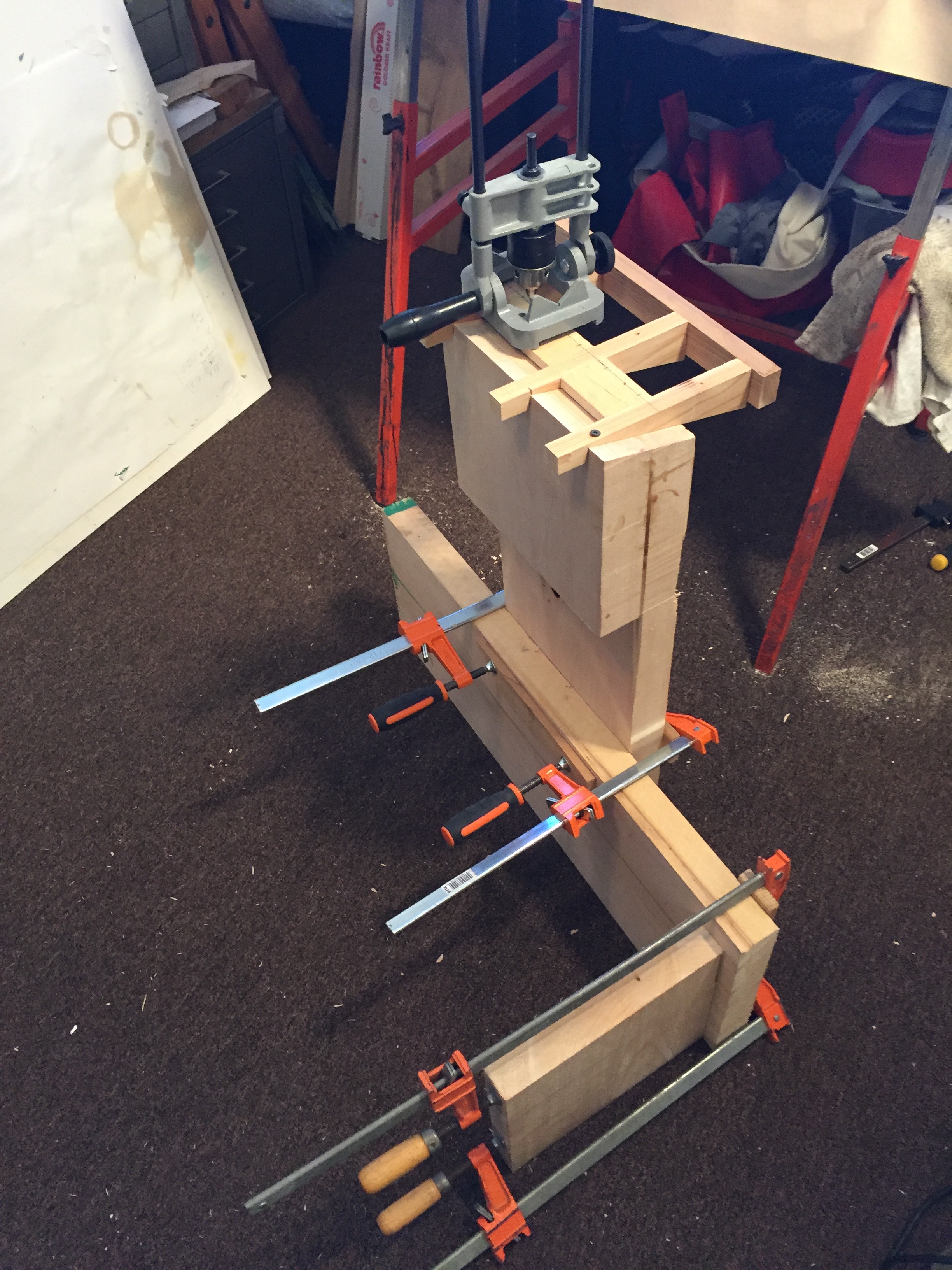Drilling holes to chisel out a mortise in the wing.
