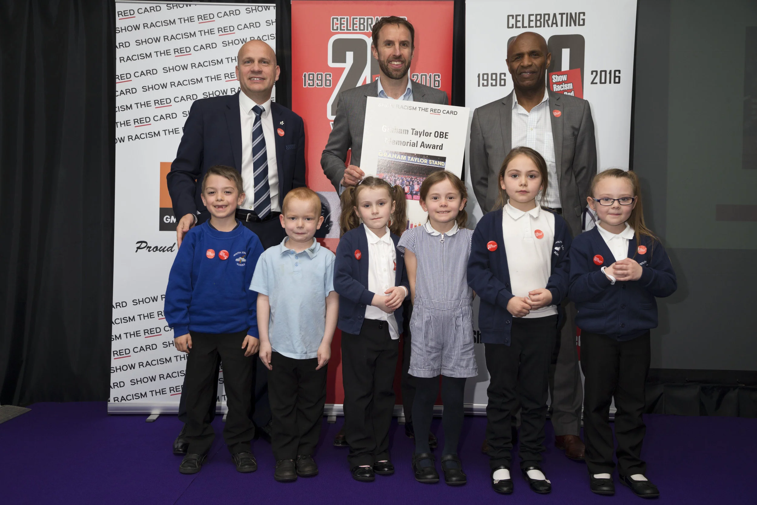 Young people from South Stanley Infants win Graham Taylor Memorial Award, with John Hudson, Gareth Southgate and Luther Blissett