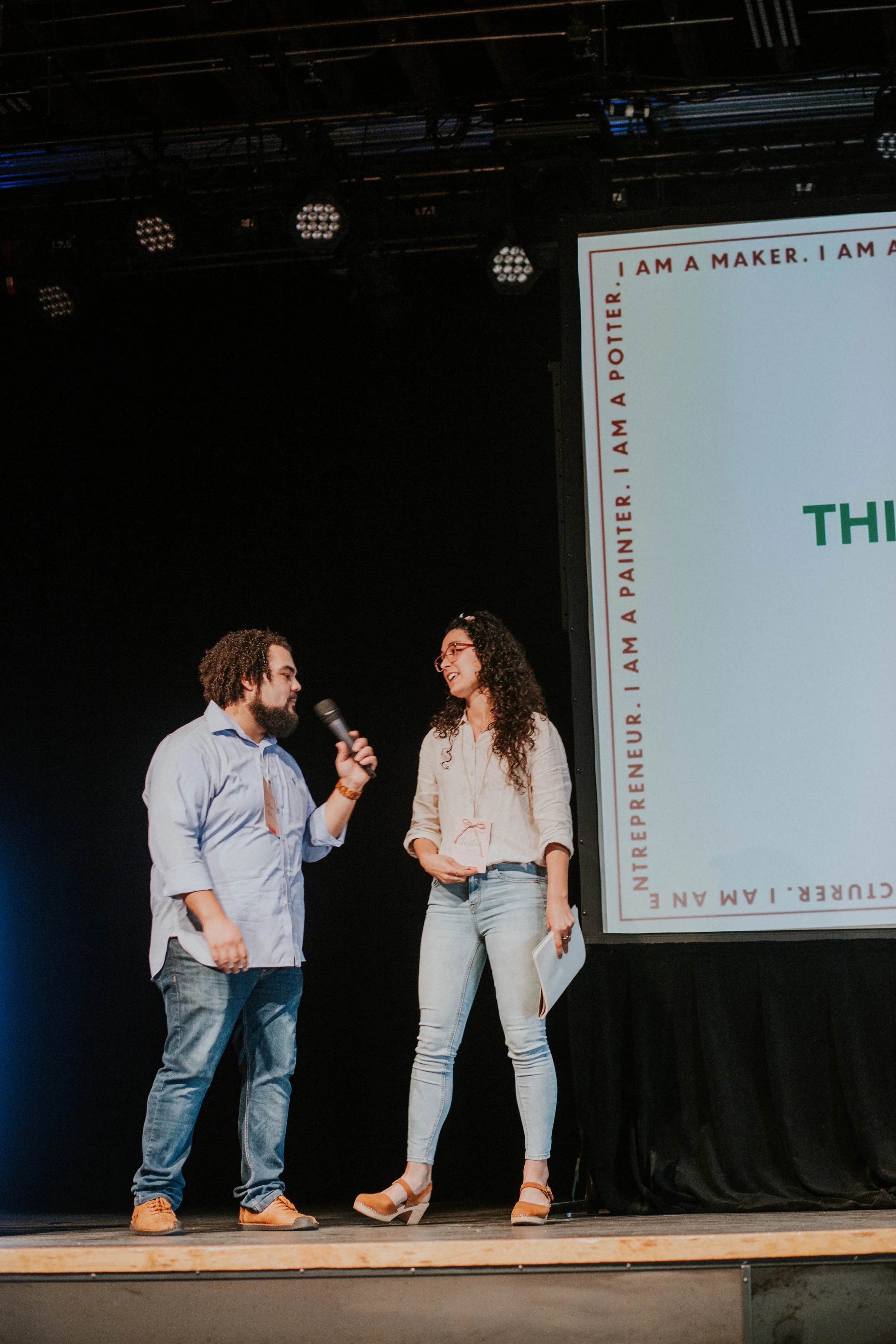 Jonathan Clark shares the mic with a maker who has written a haiku. “Sometimes you just have to get over yourself and try,” he said about using creativity. “What do you have to lose?” Photo by Miranda Mader