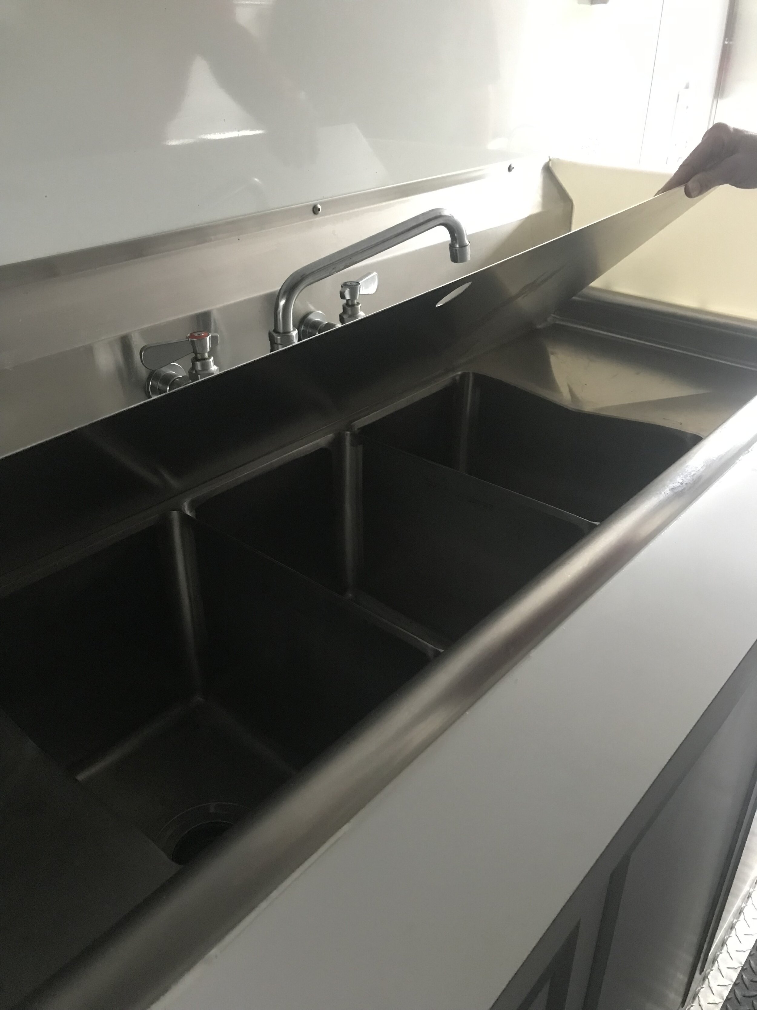  A three-bay sink comes with a cover which offers additional work space when the sink isn't in use. 