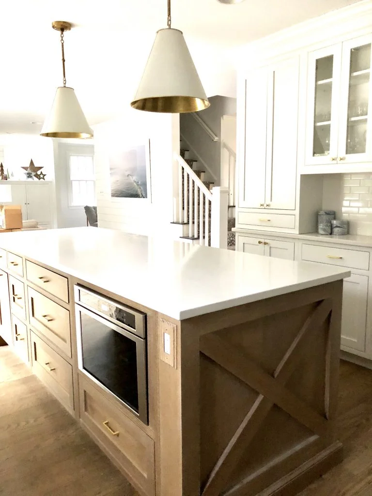 The oak kitchen island has a cerused finish that highlights the natural grain of the wood.