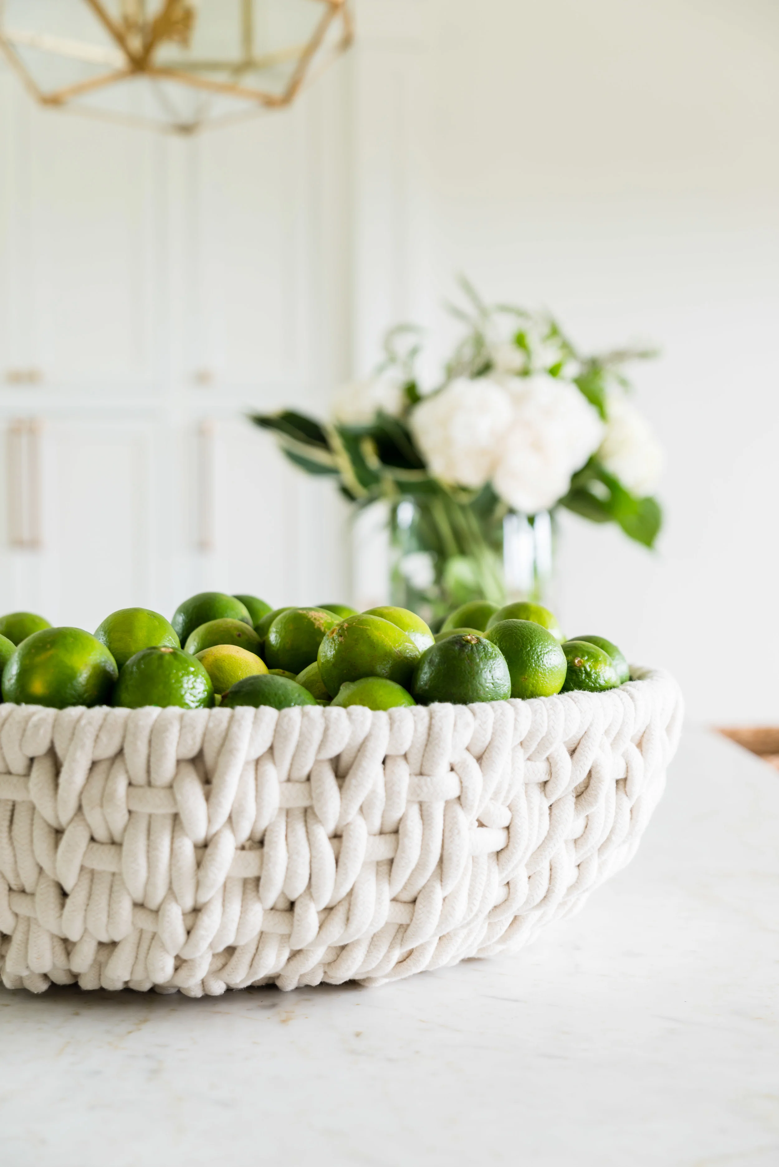 A rope bowl full of lemons