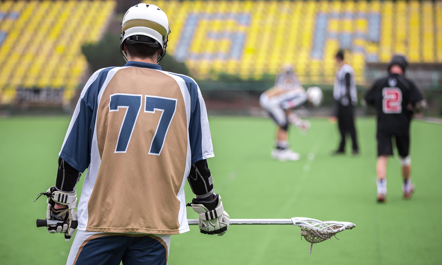 Lacrosse player and high school stadium