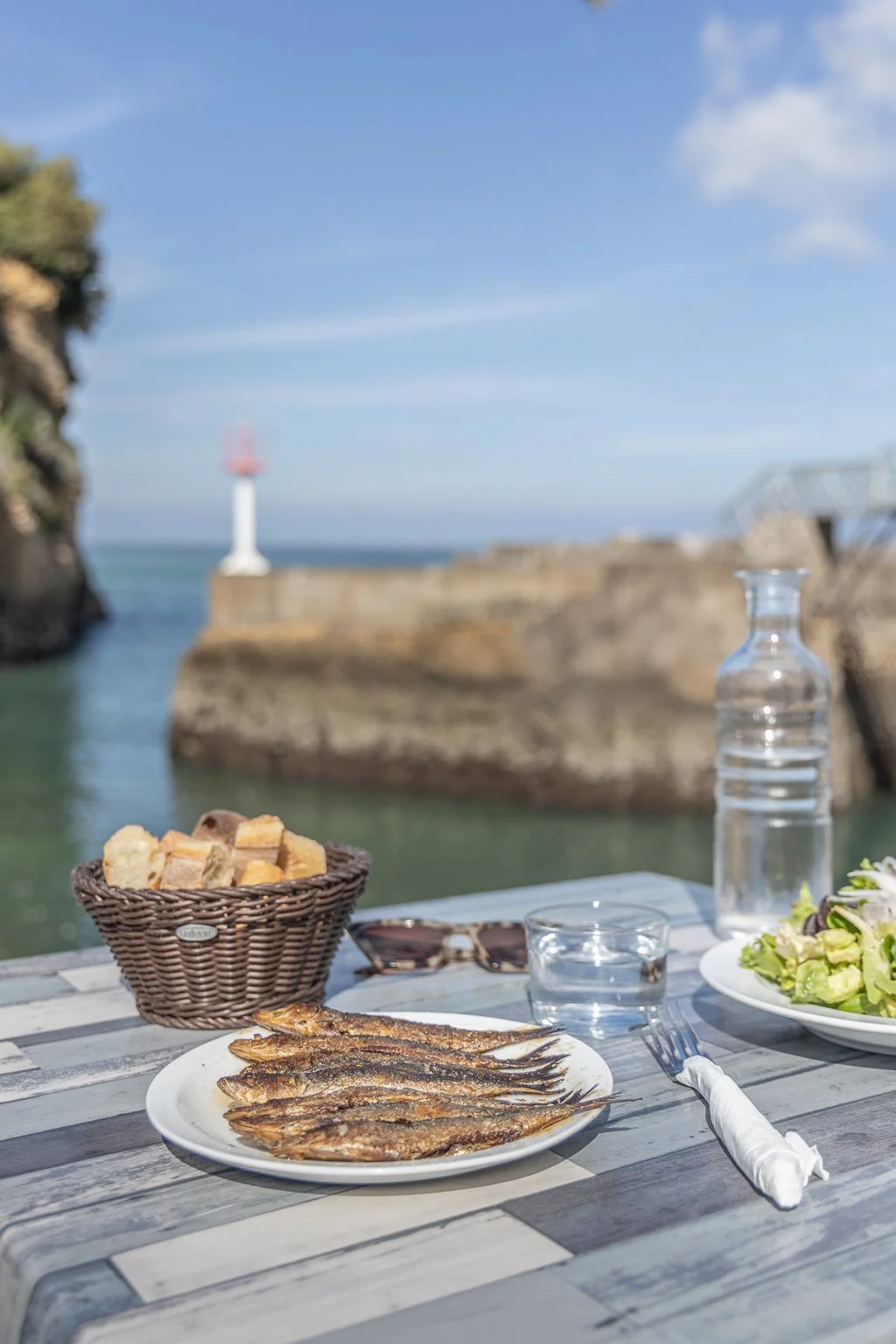 Colorful fishing boats and diners eating grilled sardines at Casa Juan Pedro in Port des Pêcheurs Biarritz