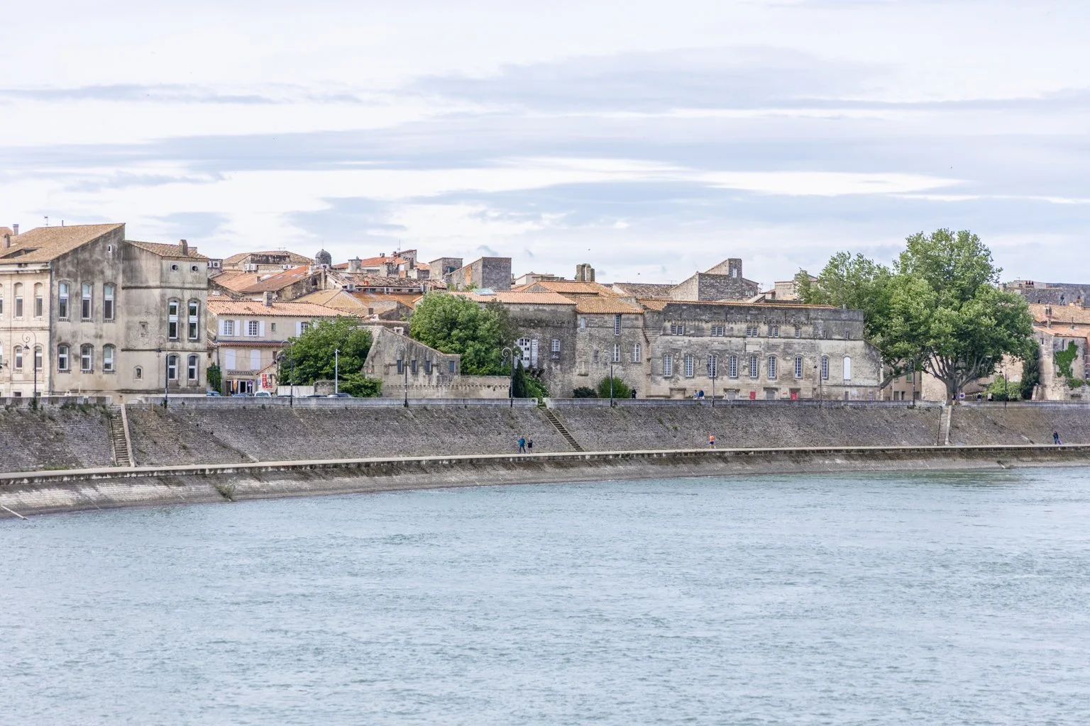 The Rhône River flowing past the historic center of Arles at sunset